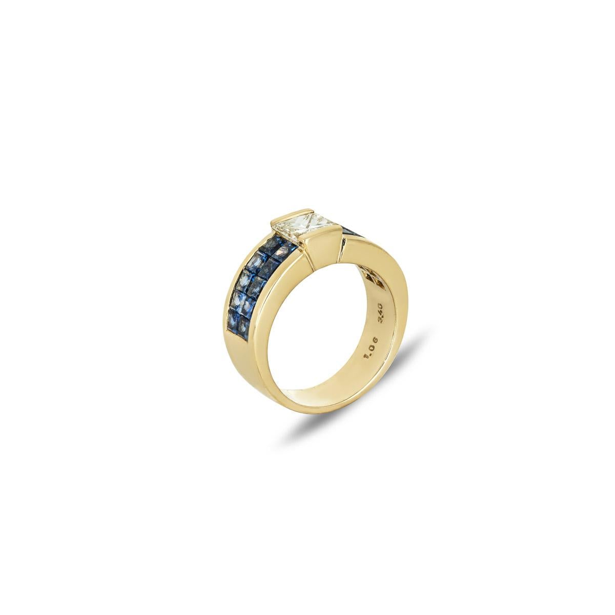 An 18k yellow gold diamond and sapphire dress ring. The ring is set to the centre in a tension setting with an approximate weight of 1.06ct, L-M colour and VS clarity. Further complementing the diamond are 10 princess cut sapphires invisible set to