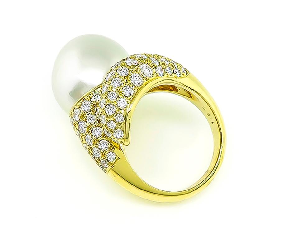 This elegant 18k yellow gold ring is set with a tear drop shape south sea pearl. The pearl is accentuated by sparkling round cut diamonds that weigh approximately 1.69ct graded E color with VS clarity. The top of the ring measures 21mm by 19mm. The