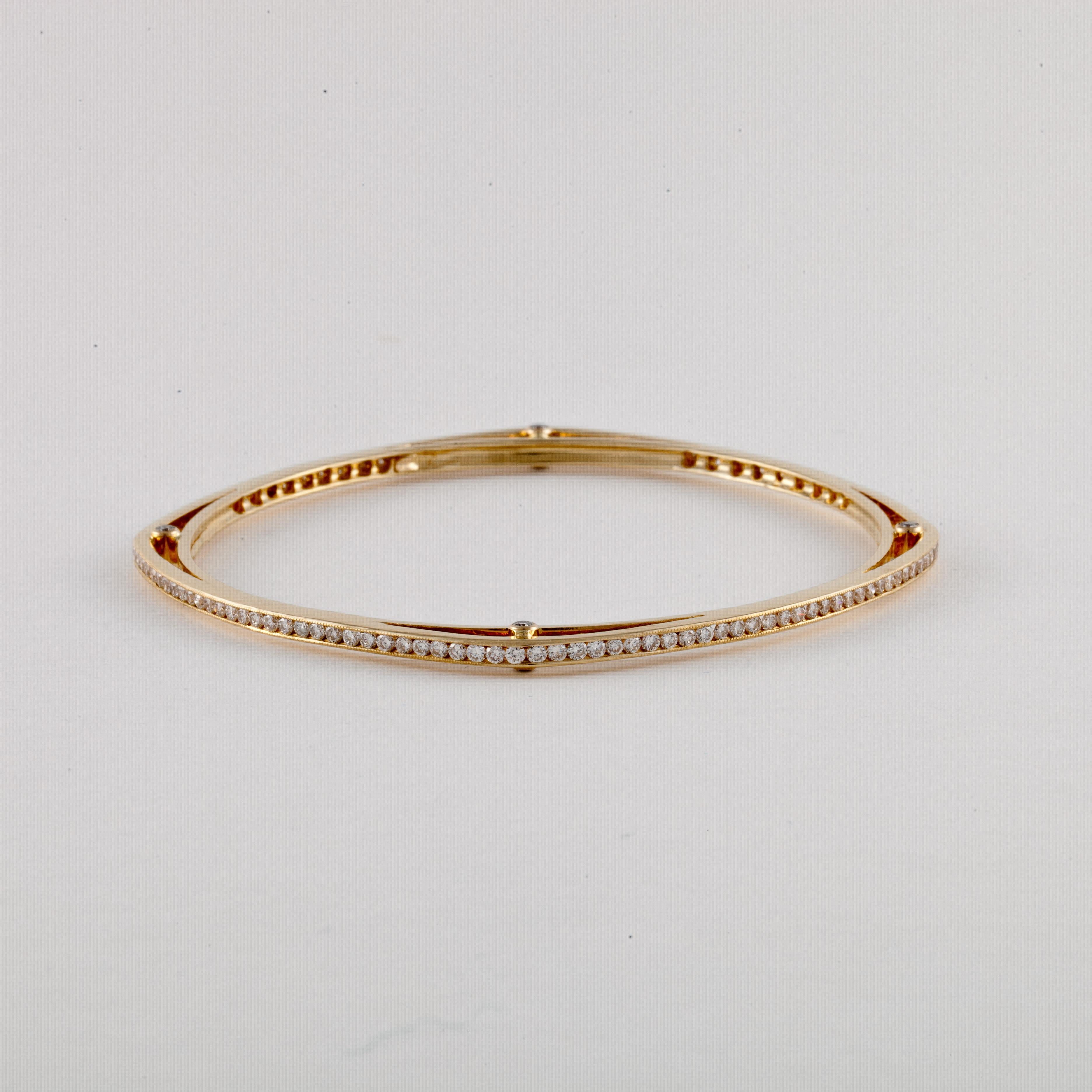 18K yellow gold bangle bracelet set with diamonds.  The shape is a rounded square with a diamond in each corner.  In addition there are diamonds encircling the bracelet.  There are a total of 136 round diamonds with 2.90 carats; G-H color and