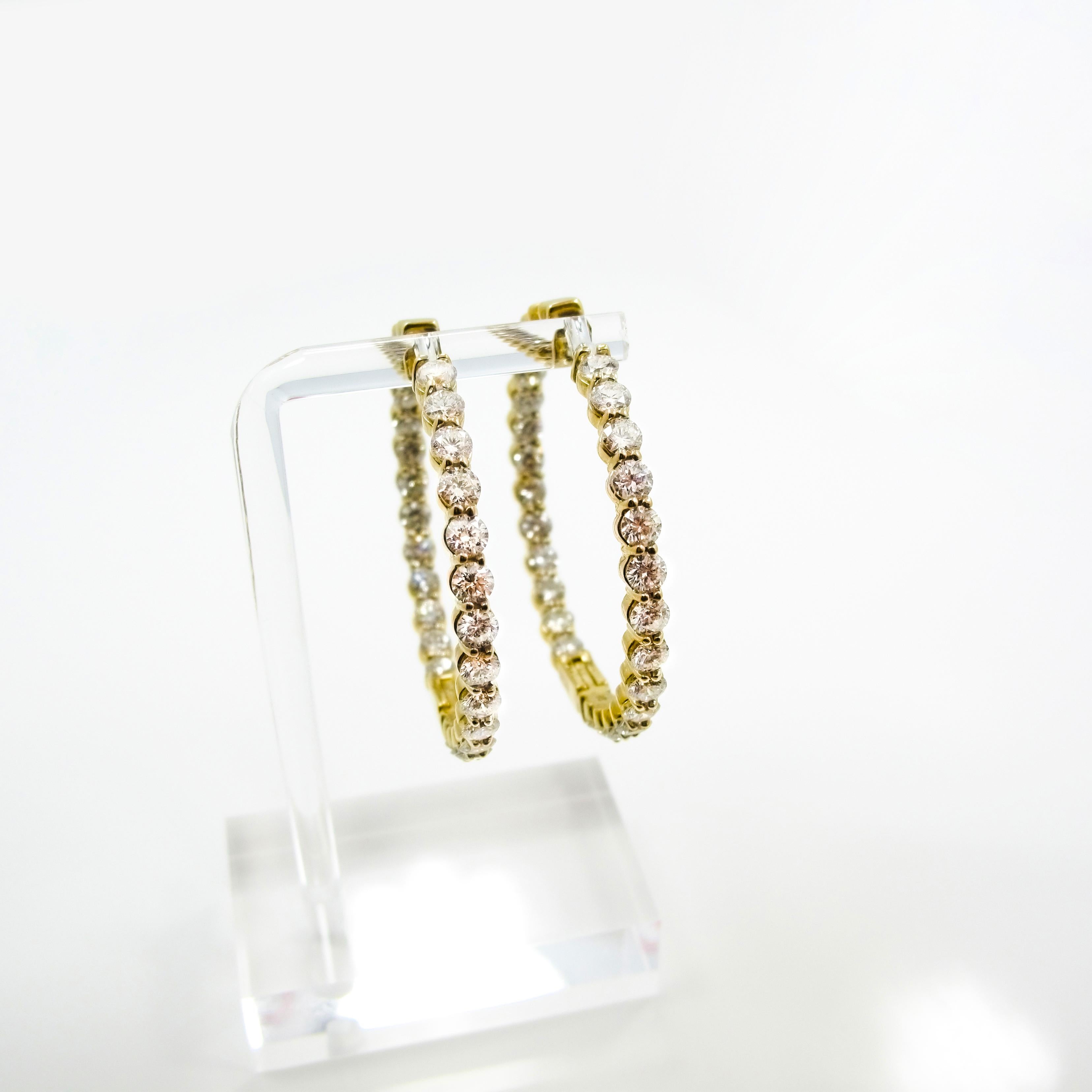 Make a statement with these! One pair of inside-outside diamond hoops set in 14k yellow gold. The pair contain 52 round brilliant diamonds in prong set baskets weighing approximately 10.40cttw, 3.7mm each, G-H in color, SI1-2 in clarity. The hoops