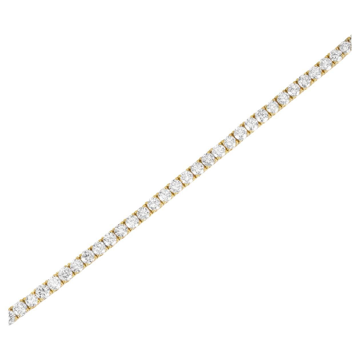 A sparkly 18k yellow gold diamond line bracelet. The tennis bracelet features 67 round brilliant cut diamonds set in a four prong mount with a total weight of 4.27ct, F-G colour and SI clarity. The 7-inch long bracelet measures 3mm in width,