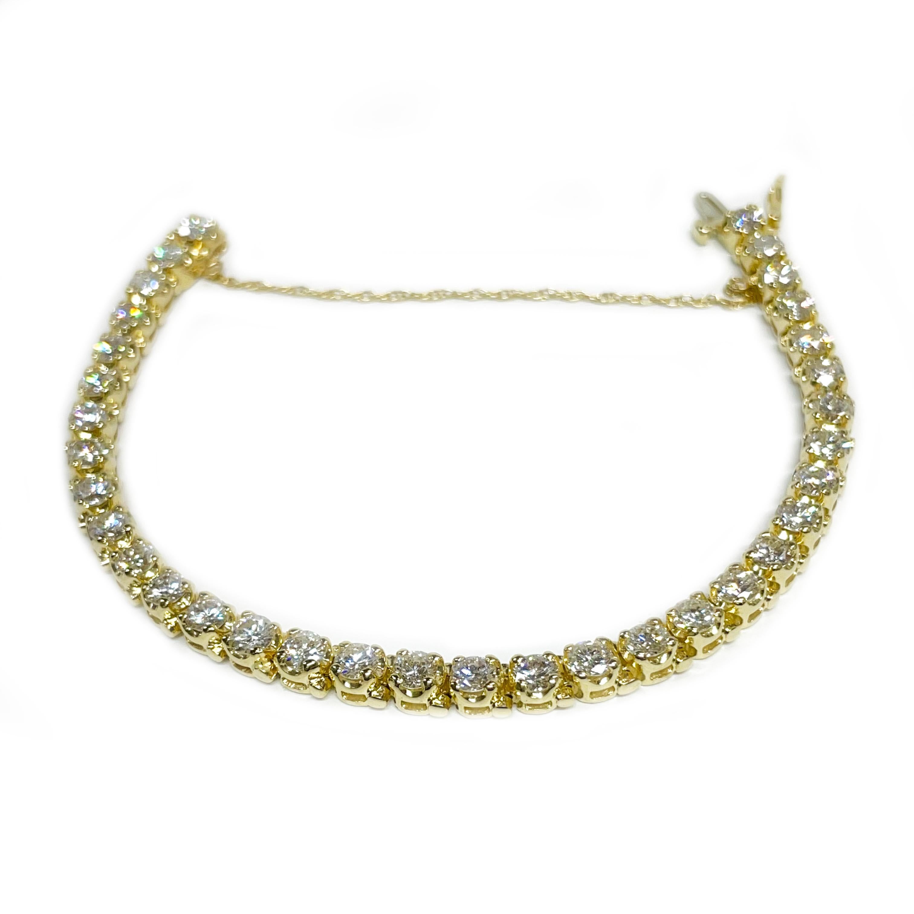 14 Karat Yellow Gold Diamond Tennis Bracelet. This gorgeous bracelet contains thirty-four round diamonds ranging from 4.0mm to 4.1mm for a total carat weight of 8.62ctw. The diamonds are VS1-VS2 in clarity (G.I.A.) and G-H in color (G.I.A.). The