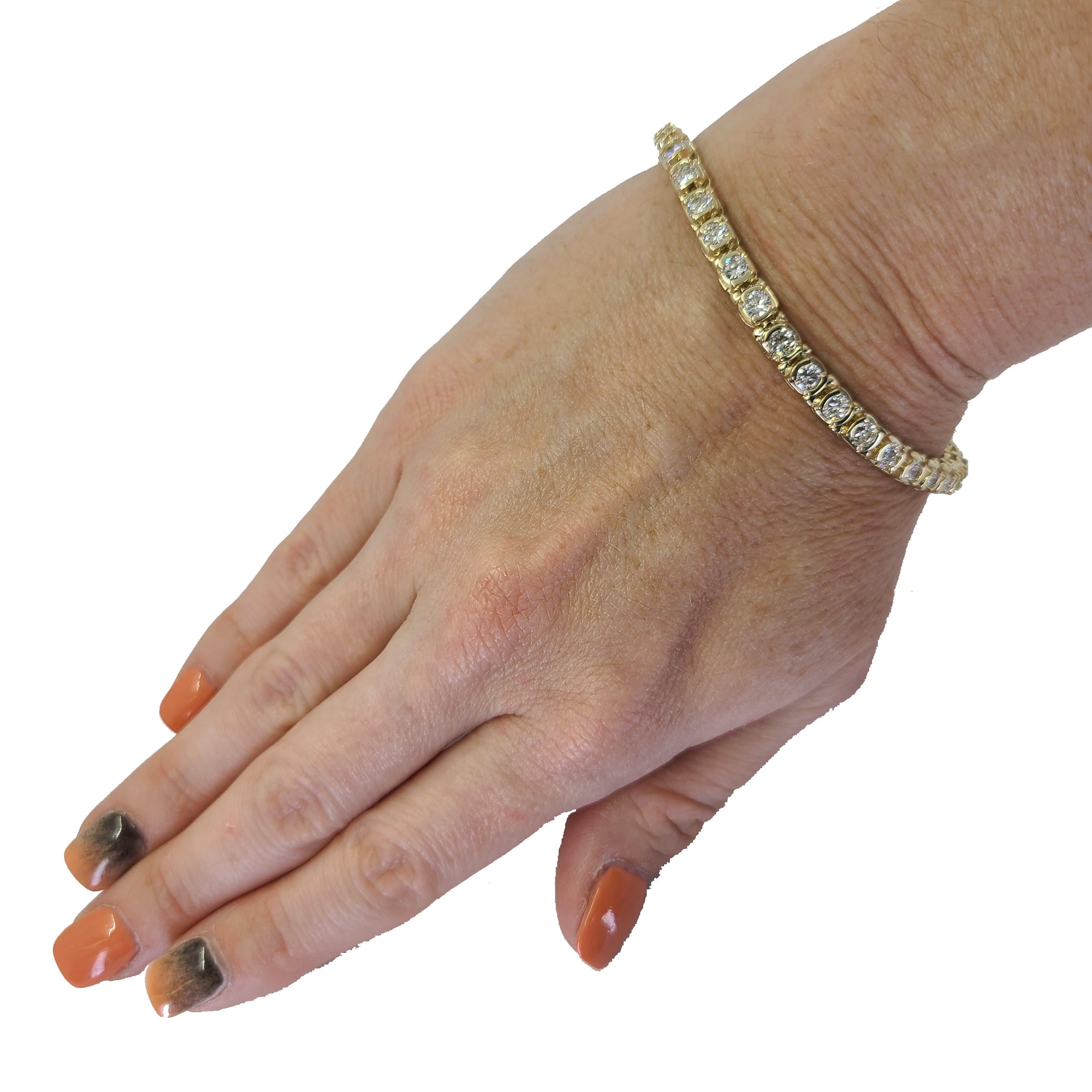 14 Karat Yellow Gold Line Bracelet Featuring 34 Half Bezel Set Round Brilliant Cut Diamonds Of SI Clarity & H Color Totaling 5.20 Carats. 7.1 Inch Length. Finished Weight Is 19 Grams.