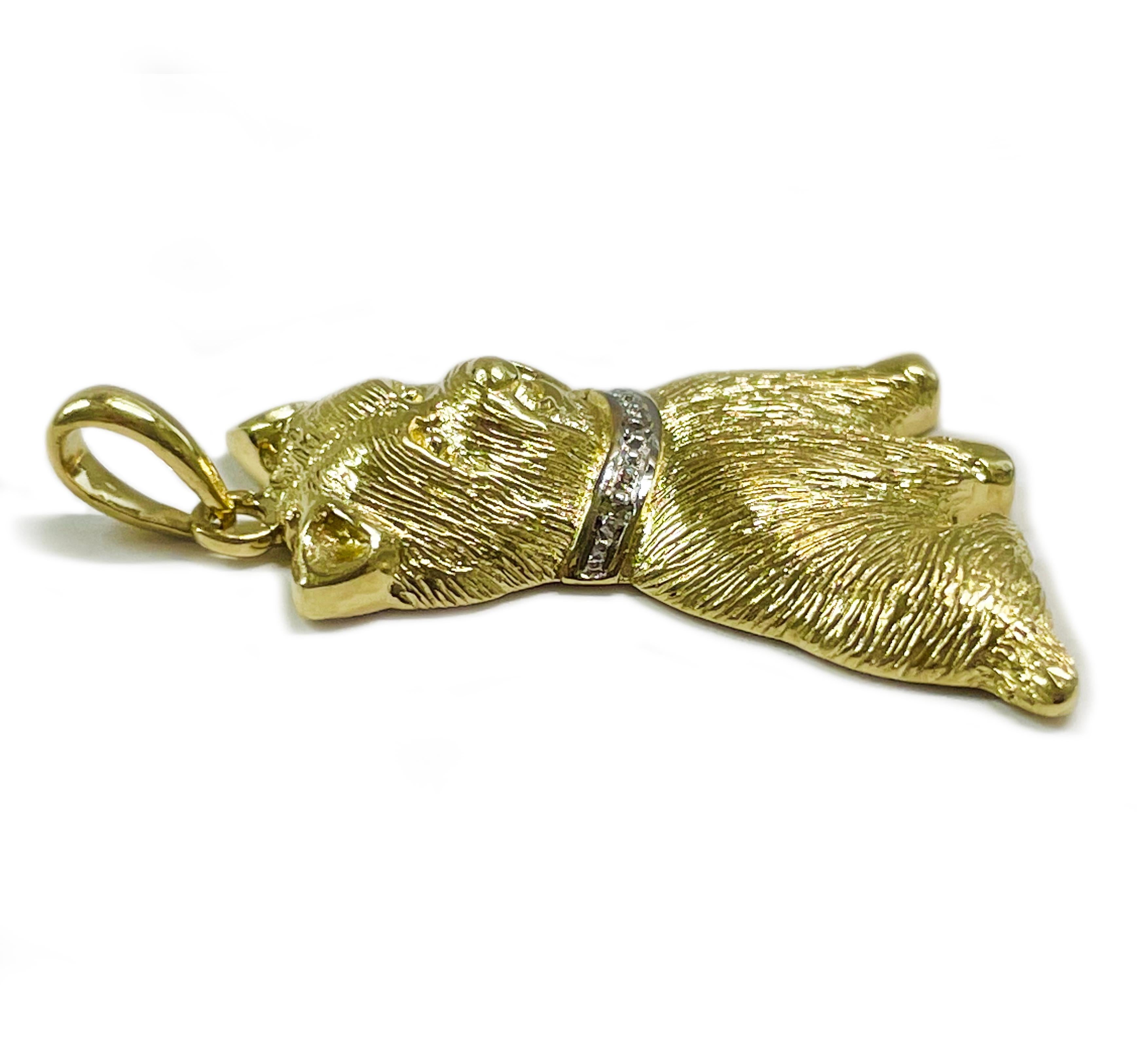 10 Karat Yellow Gold Diamond Terrier Dog Pendant. The adorable pendant of a Terrier dog is highly textured with three small round diamonds set in white gold on the collar. The pendant measures 24.3 high x 20.2mm wide. Stamped on the back of the