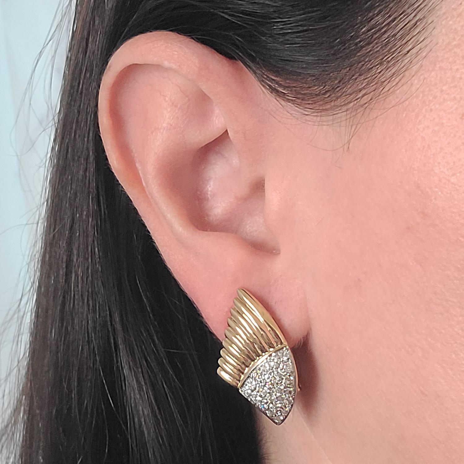 14 Karat Yellow Gold Earrings Featuring A Pave Ribbed Wing Design. 44 Round Brilliant Cut Diamonds of VS Clarity and G/H Color Total Approximately 1.00 Carat. Pierced Post with Supportive Omega Clip Back. Finished Weight Is 8.2 Grams.