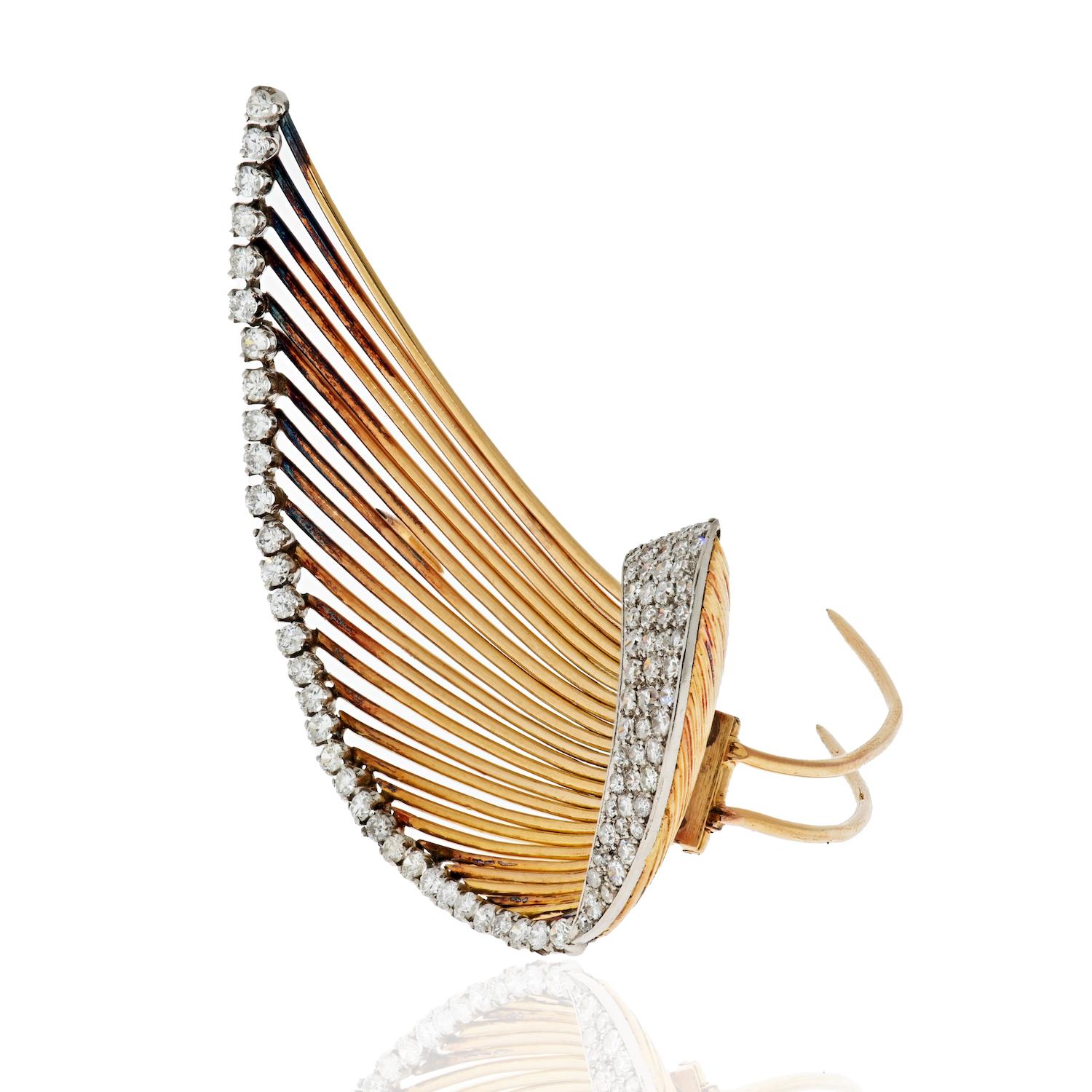 Brooch is designed as a stylized swoosh or leaf comprised of high polished yellow gold wires. 
Featuring single-cut round diamonds at the tip of every wire and pavè diamonds on the bottom element. 
Length: 2.5 inches
Diamond Weight: 3.00cts 
Circa: