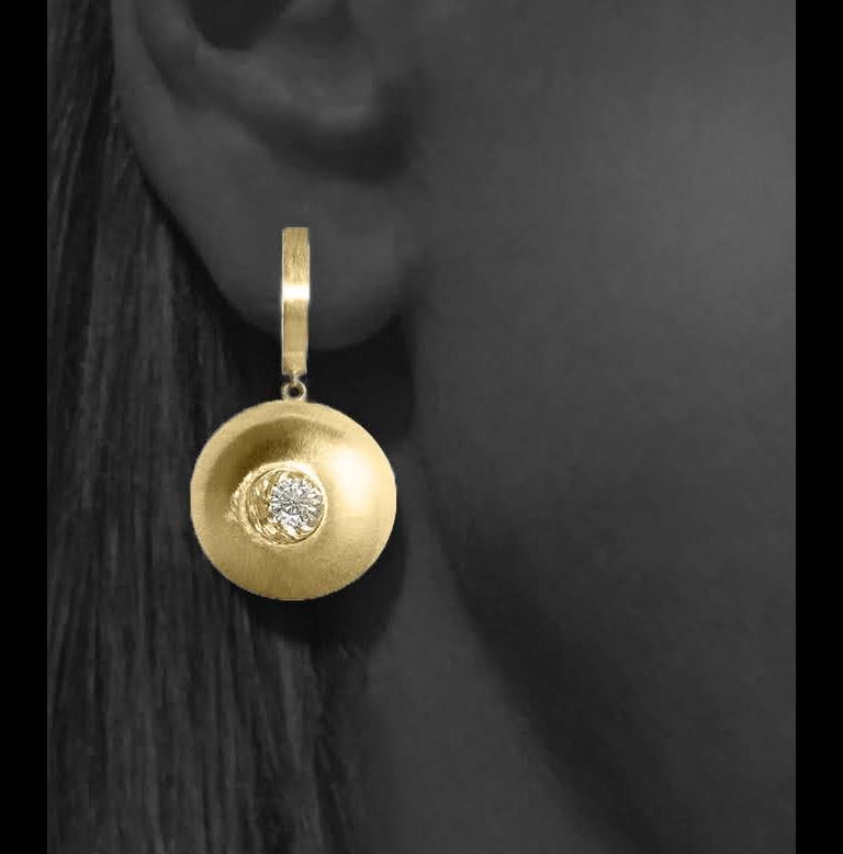 These White Sapphire in Yellow Gold Dome Drop Earrings, part of our Power Series, are a symbolic design inspired by the idea of looking inward, the notion of what a person needs is already inside of them. The clean and classic lines are imaginative,