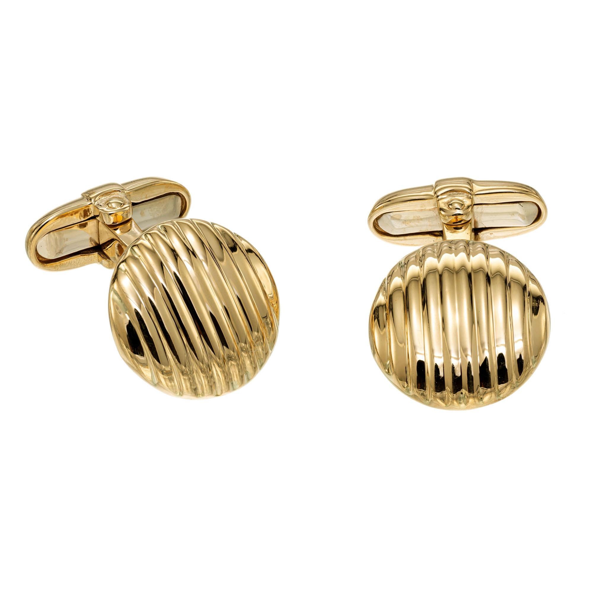 Domed round corrugated cufflinks with hinged clip backs in 18k yellow gold.

18k yellow gold
Stamped: 750
13.4 grams
Top to bottom: 16.2mm or 5/8 Inch
Width: 15.7mm or 5/8 Inch
Depth or thickness: 3.3mm

