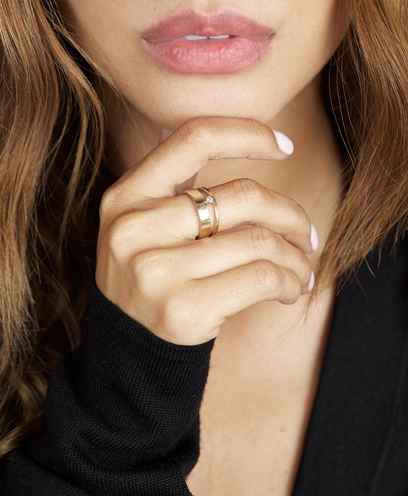 2 recycled yellow gold bands of varying heights frame a single conflict-free white diamond that hovers in the space between.  The strong architectural character of this ring is a substantial presence, bold and weighty.  Ideal as a strong everyday