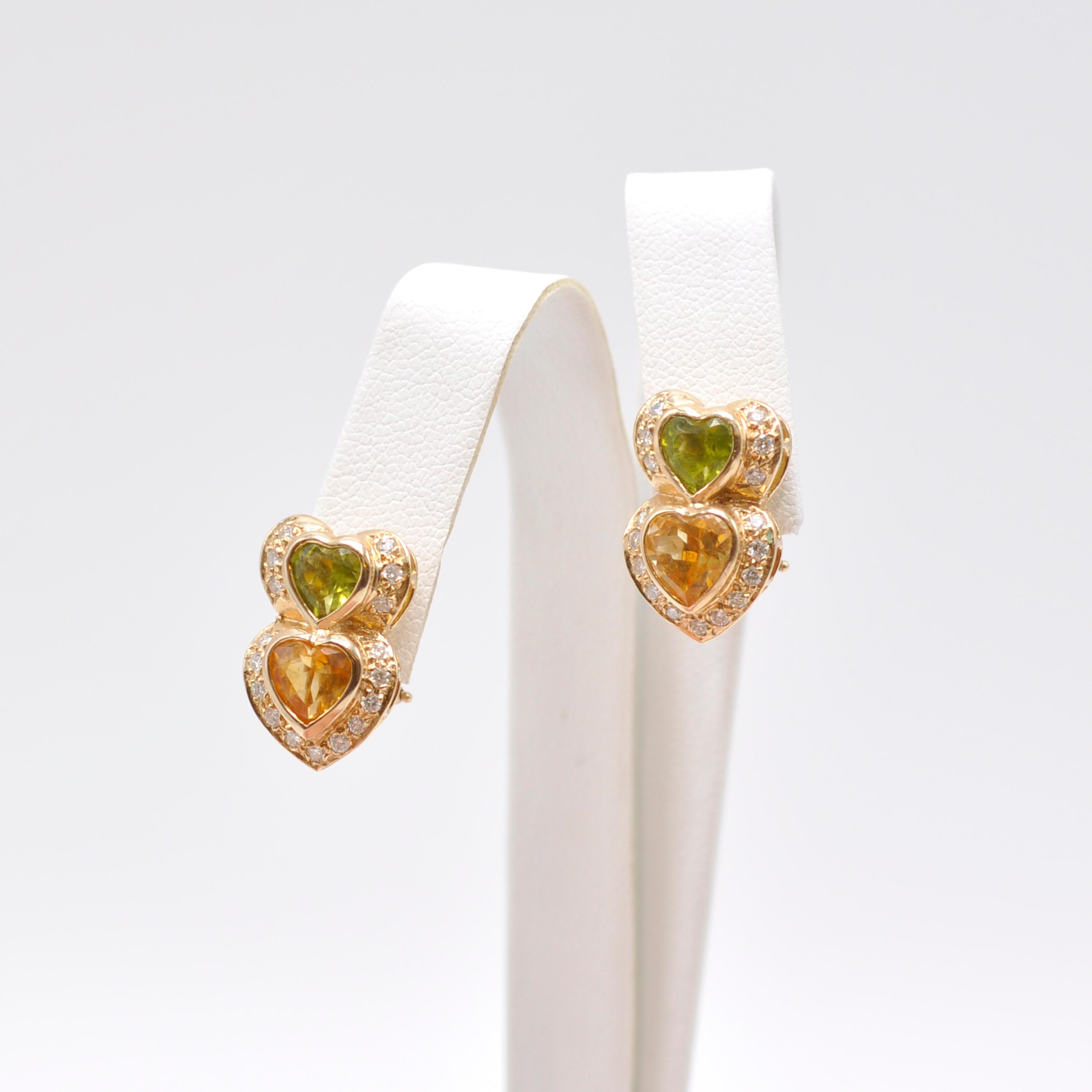 These darling earrings are the perfect for a gift for a loved one or yourself! 

Peridot hearts sit on top of citrine hearts surrounded by .3 cts of round cut diamonds all set in 14 Karat yellow gold. Post clip backs secure the earrings to your ear