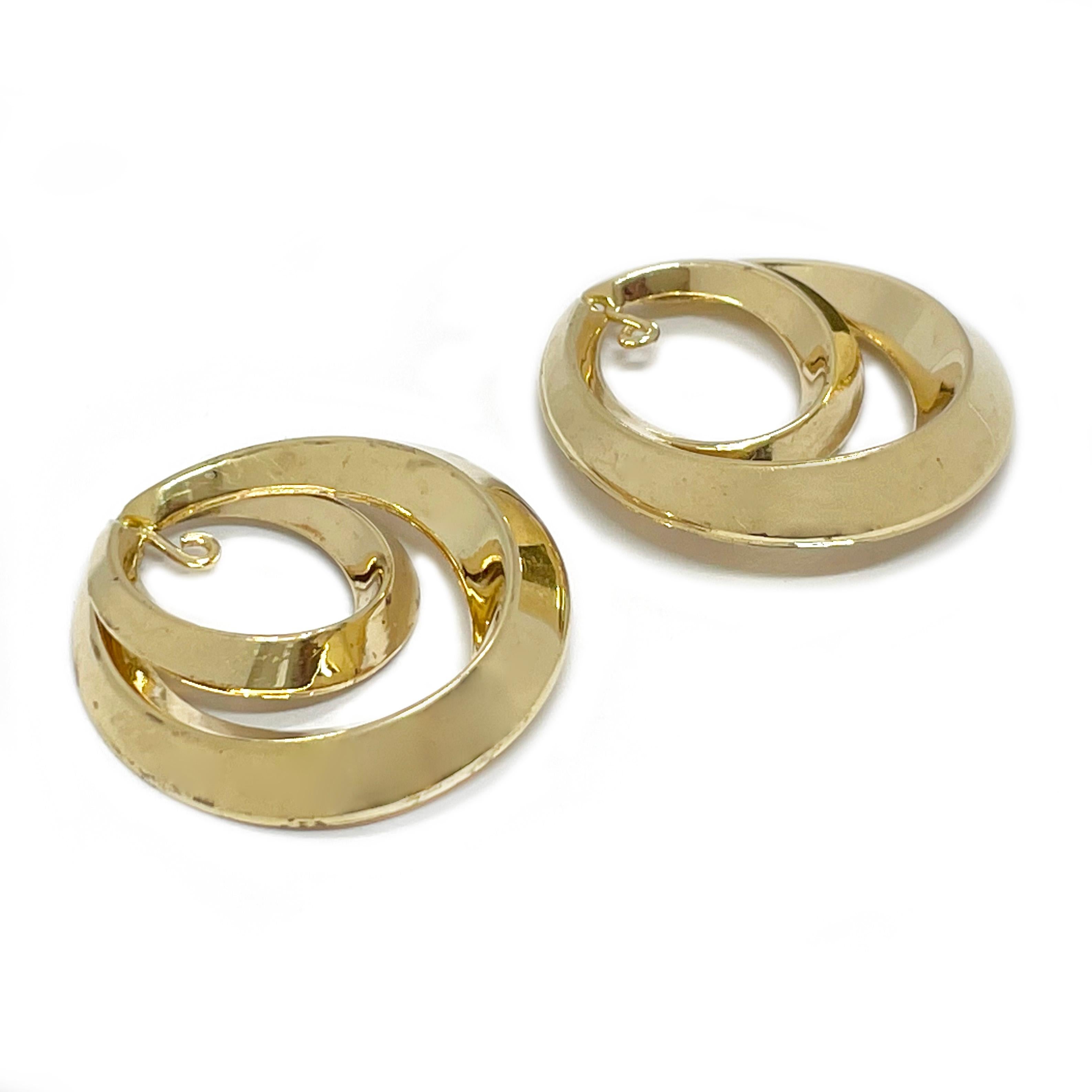 14 Karat Yellow Gold Double Beveled Hoop Earring Jackets. Add these earring jackets to any studs for an extra flair. The jackets feature smooth shiny double beveled hoops with a hanging wire opening coming down from the top of the earring jacket to