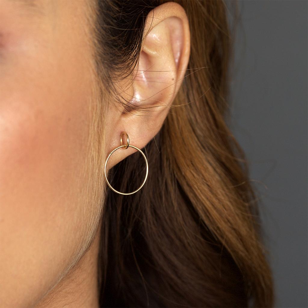 A new take on a hoop, this earring has two interlocking rings, one of which seems to sit right on its edge as the post.  Day to night, you'll be living in these as your go-to earrings.
Available in solid recycled 14k yellow gold.  Sold as a pair,