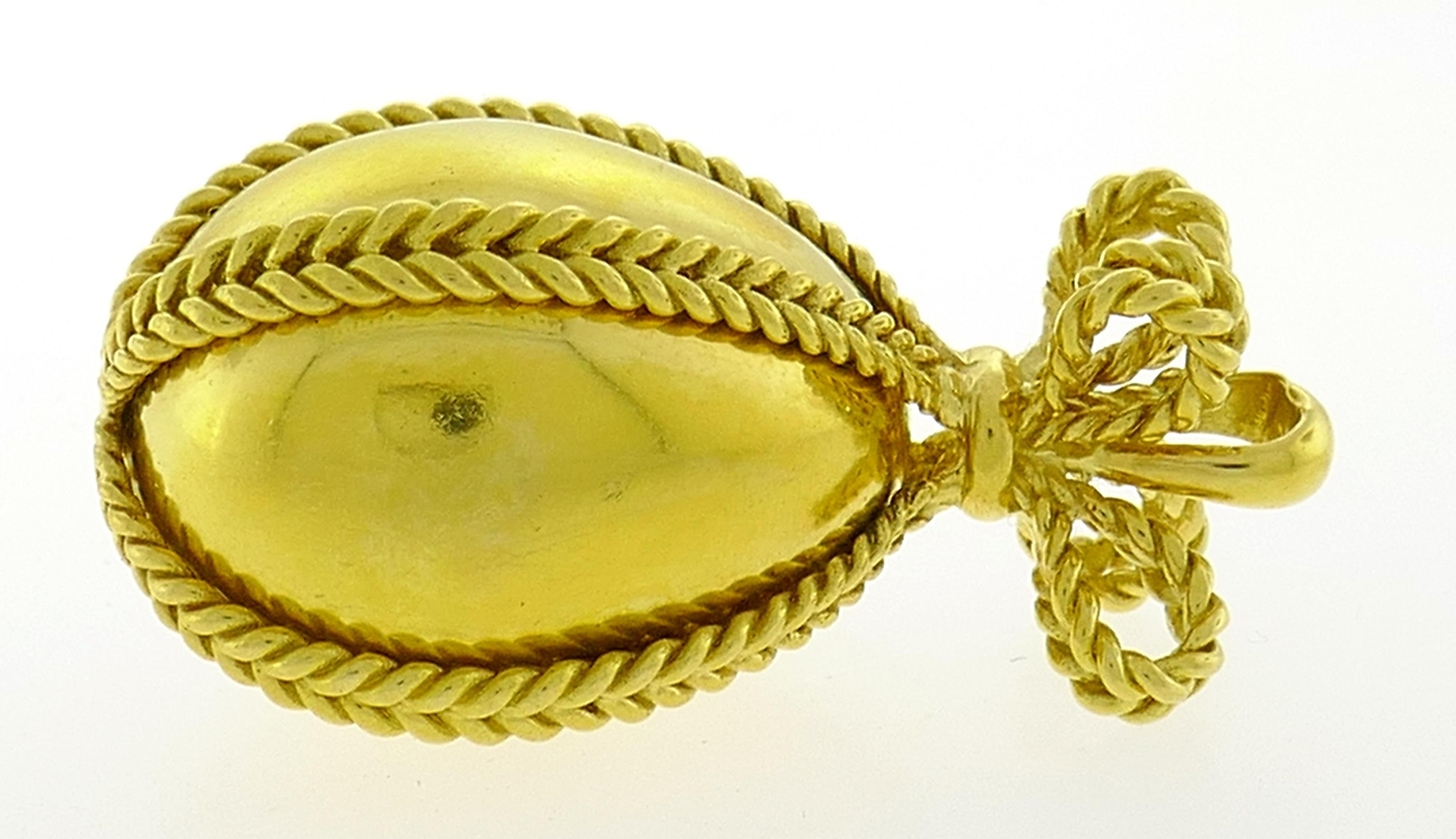 Lovely egg charm pendant created in France in the 1980s. 
The pendant is made of 18 karat (tested) yellow gold. 
The pendant measures 1-1/2 x 3/4 inches (3.8 x 1.8 centimeters) and weighs 15.8 grams. 
The bail is stamped with French hallmark for 18