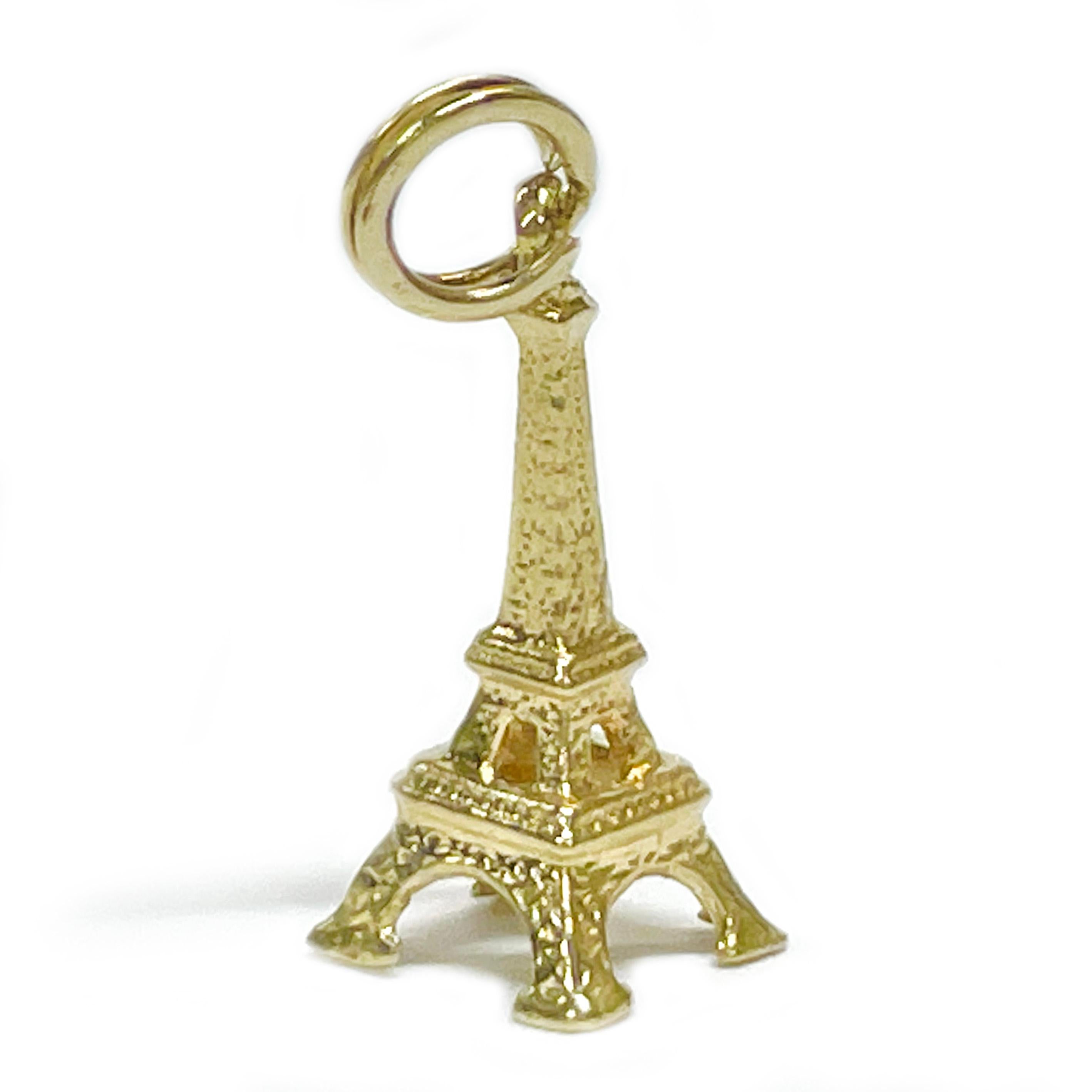 Tested 14 Karat Yellow Gold Eiffel Tower Charm Pendant. This darling charm pendant features details in harmony with the real structure in Paris, France. The pendant measures 20.9mm high (not including split ring) x 8.3mm wide. Wear on a necklace or