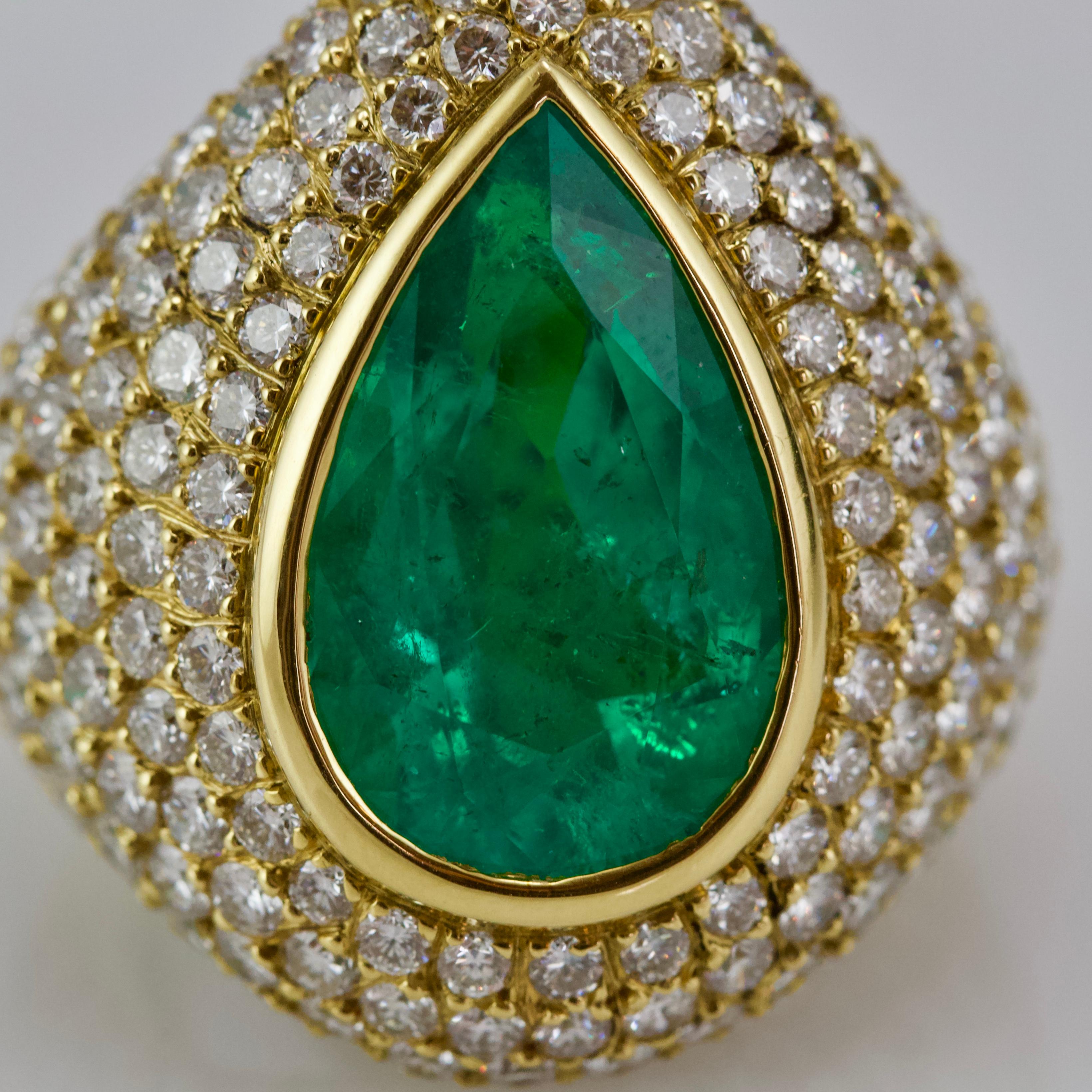 Yellow gold, diamond and emerald cocktail ring. 
Box set pear shaped emerald weight approximately 8 carats in a dome 2 of diamonds weight almost 7 carats 
Circa 1980
Color: medium green
Clarity: naturals inclusions
Quality of diamonds: H VS
French