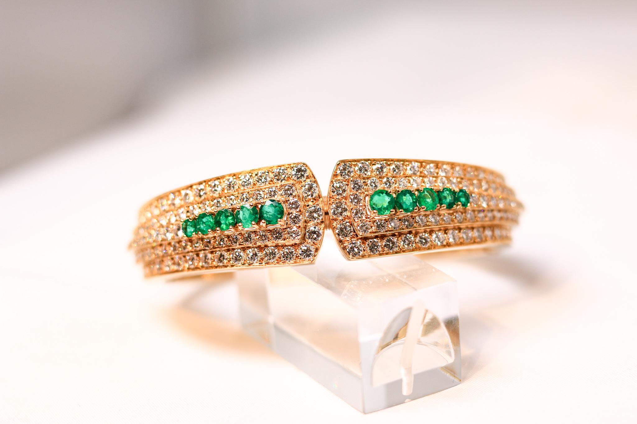 18 K Yellow Gold Pave Bangle Bracelet with Emeralds.  Hinged Clasp and Safety Chain.  Stamped 750.Fits standard size 7 inch wrist. This piece is stunning.  10 graduated emeralds.  