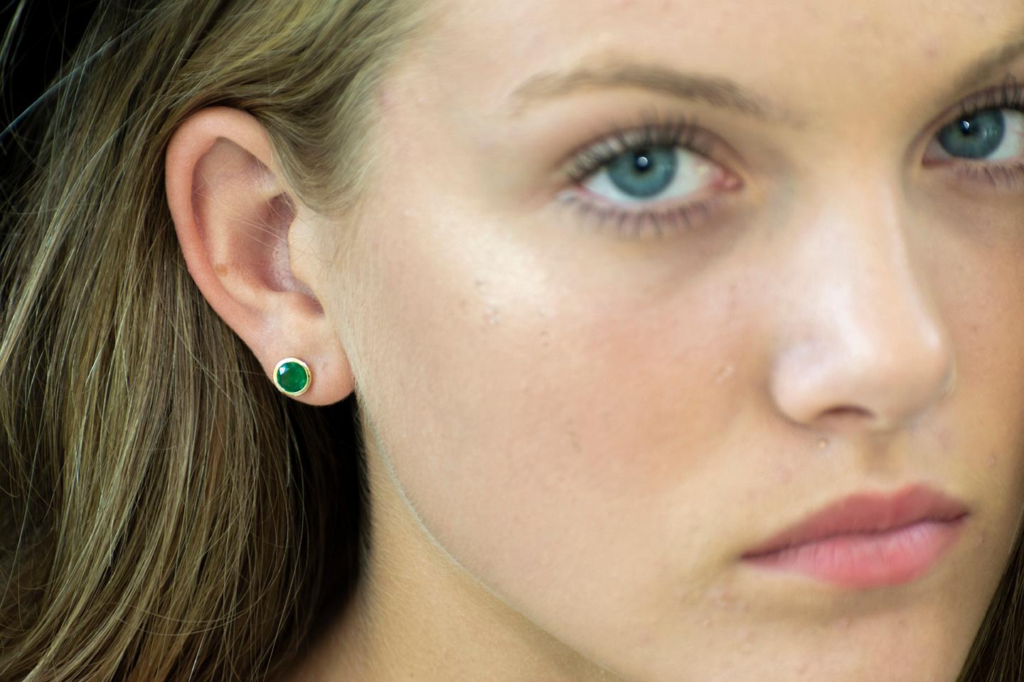Featuring 14k yellow gold bezel-set 6 mm Colombian emerald stud earrings 
Emerald weighing 1.30 carats
width of the earrings 6.85 mm
New Earrings
Our design team select gemstones for their quality, aesthetic beauty and sale value of the featured