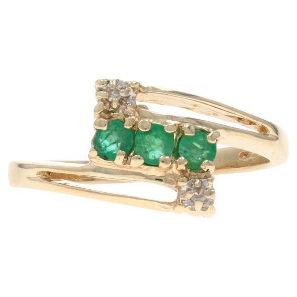 Yellow Gold Emerald Diamond Bypass Ring - 10k Round .31ctw Three-Stone For Sale