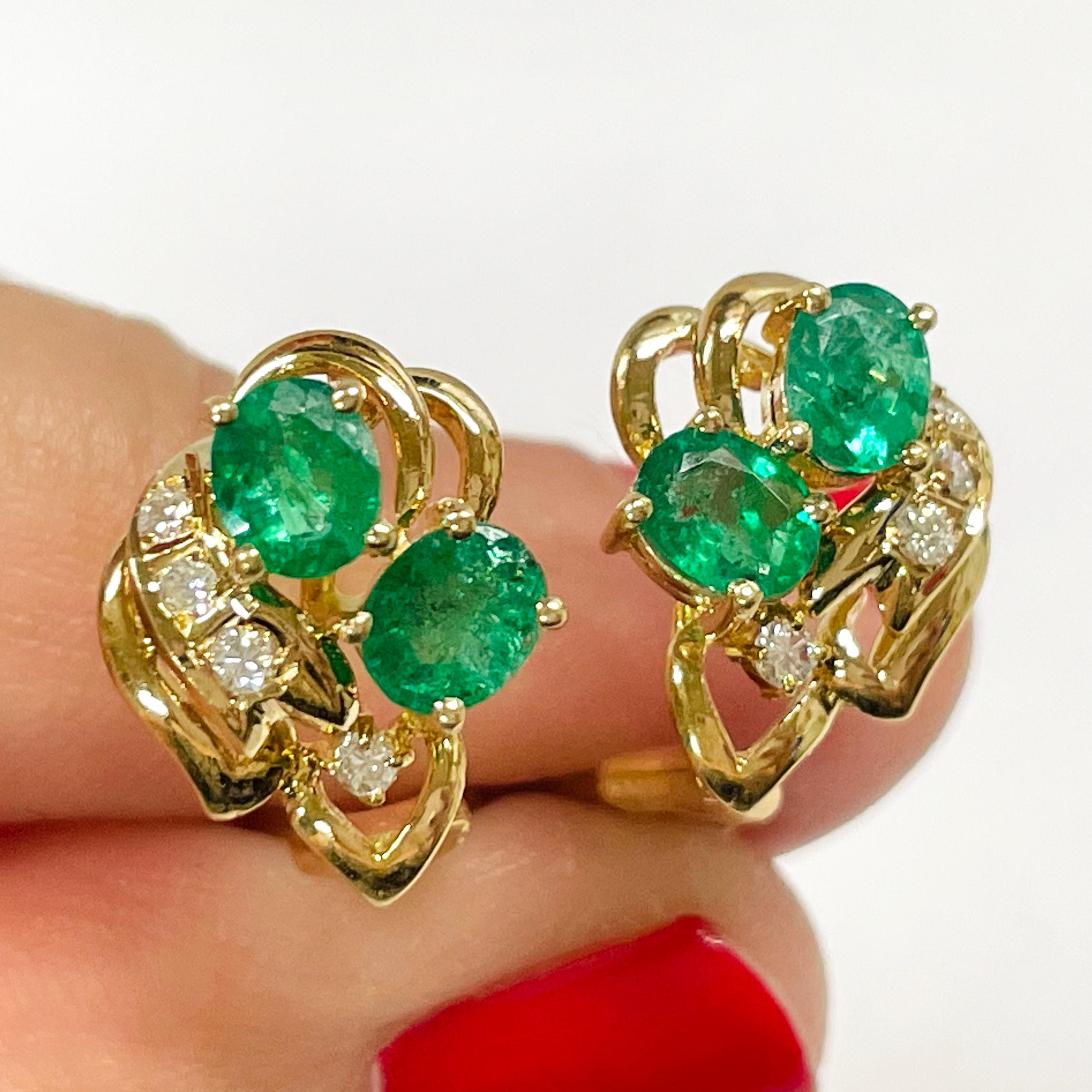 14 Karat Yellow Gold Emerald Diamond Earrings. Each earring features two basket set oval emeralds and four round diamonds. The four emeralds measure 5 x 4mm for a carat total weight of 1.50ctw. The earrings have a post and an omega clip. The