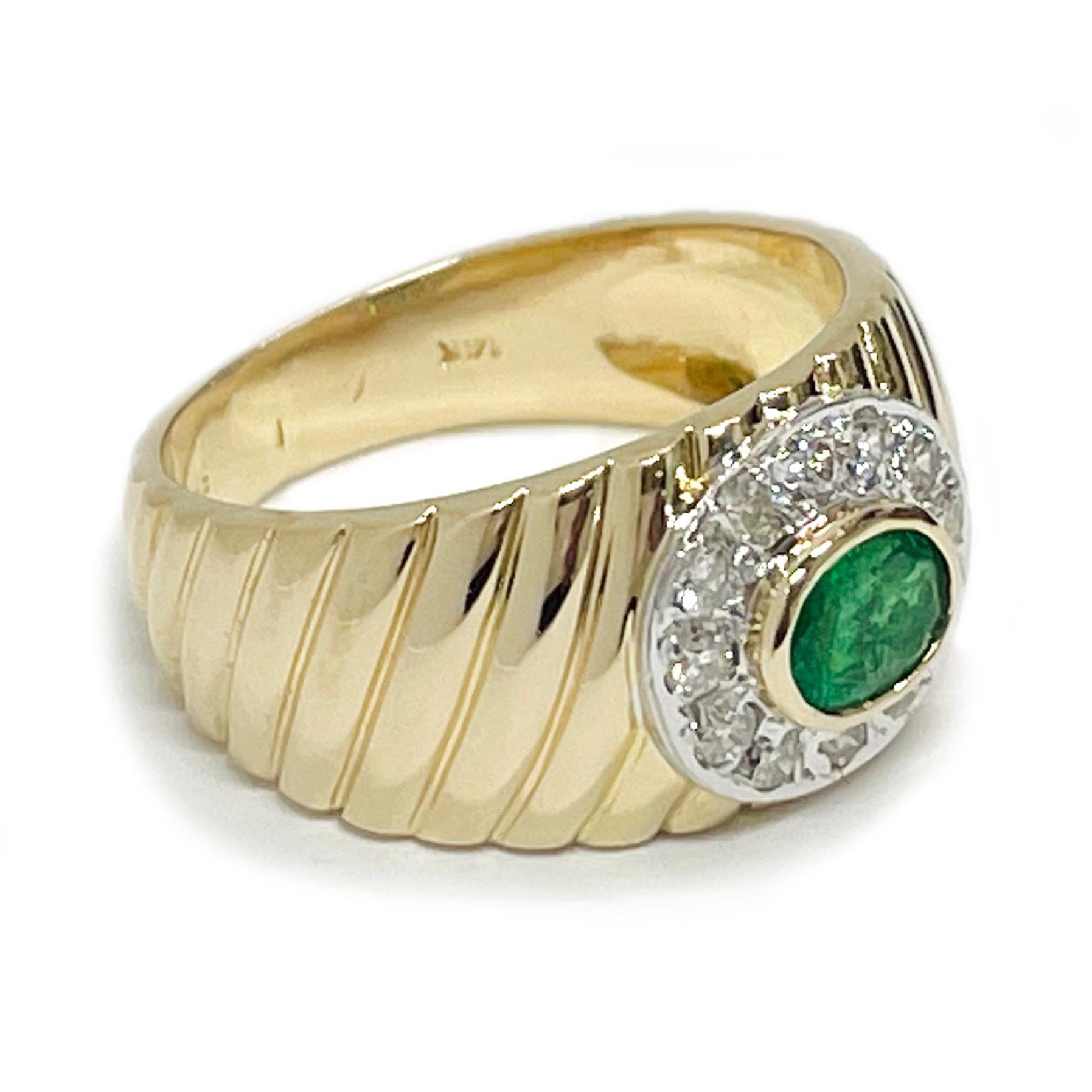 14 Karat Yellow and White Gold Emerald Diamond Ridged Ring. This lovely ring features a center oval emerald with a diamond surround. The bezel-set emerald measures 5 x 4mm for a carat total weight of 0.35ct. The twelve round bead-set diamonds