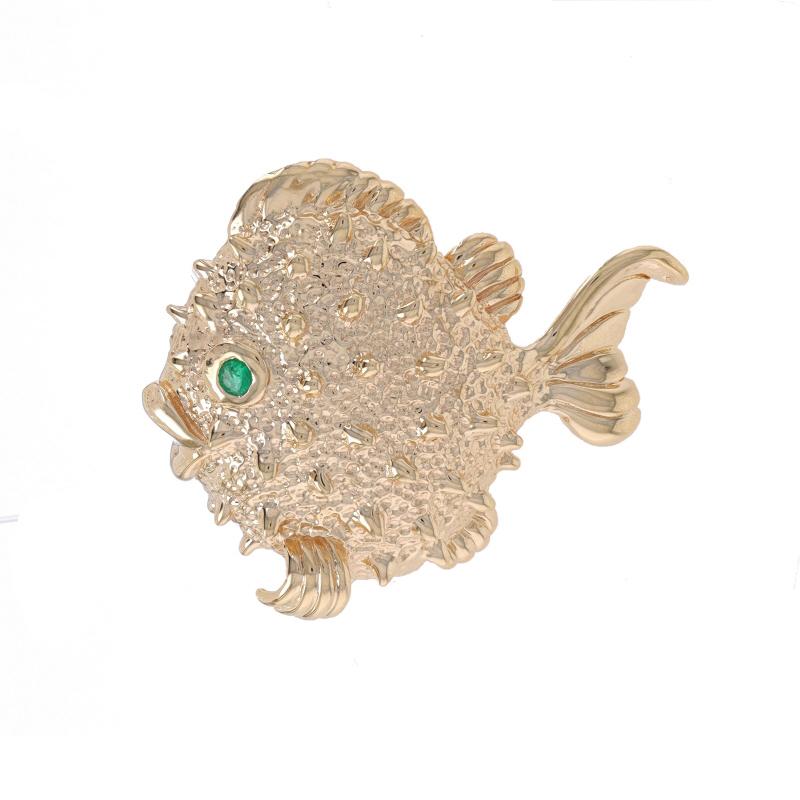 Metal Content: 14k Yellow Gold

Stone Information
Natural Emerald
Treatment: Oiling
Carat(s): .03ct
Cut: Round
Color: Green

Style: Brooch
Fastening Type: Hinged Pin and Whale Tail Clasp
Theme: Fish, Aquatic Life
Features: Smooth & Textured