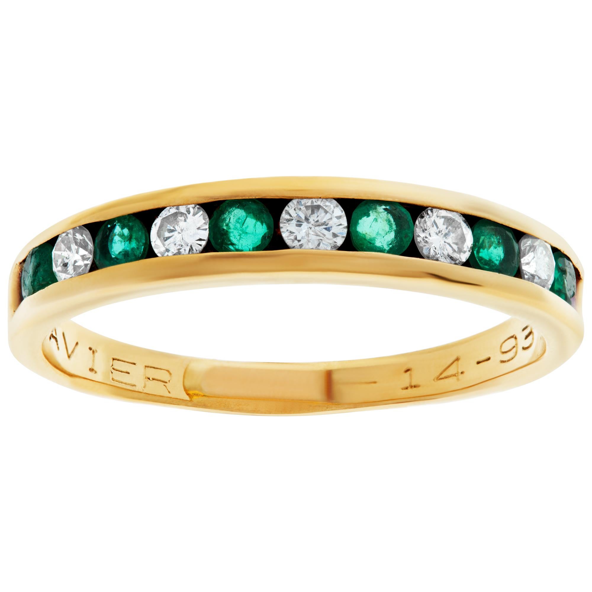 Emerald and diamond semi eternity band in 14k yellow gold. Round brilliant cut diamonds total approx. weight: 0.20 carat (all white & eye clean). Oval brilliant cut emerald total approx. weight: 0.24 carat.Width 3.5mm. Size 7.5.This Diamond/Emerald