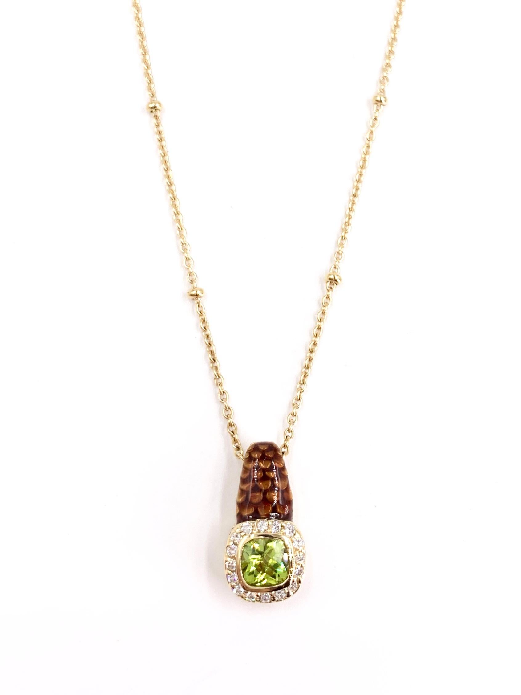 A unique pendant necklace featuring a .95 carat vibrant cushion cut peridot surrounded by .20 carats of white round brilliant diamonds, dropping beautifully from a hand painted brownish-gold enamel bale. Diamond quality is approximately G-H color,