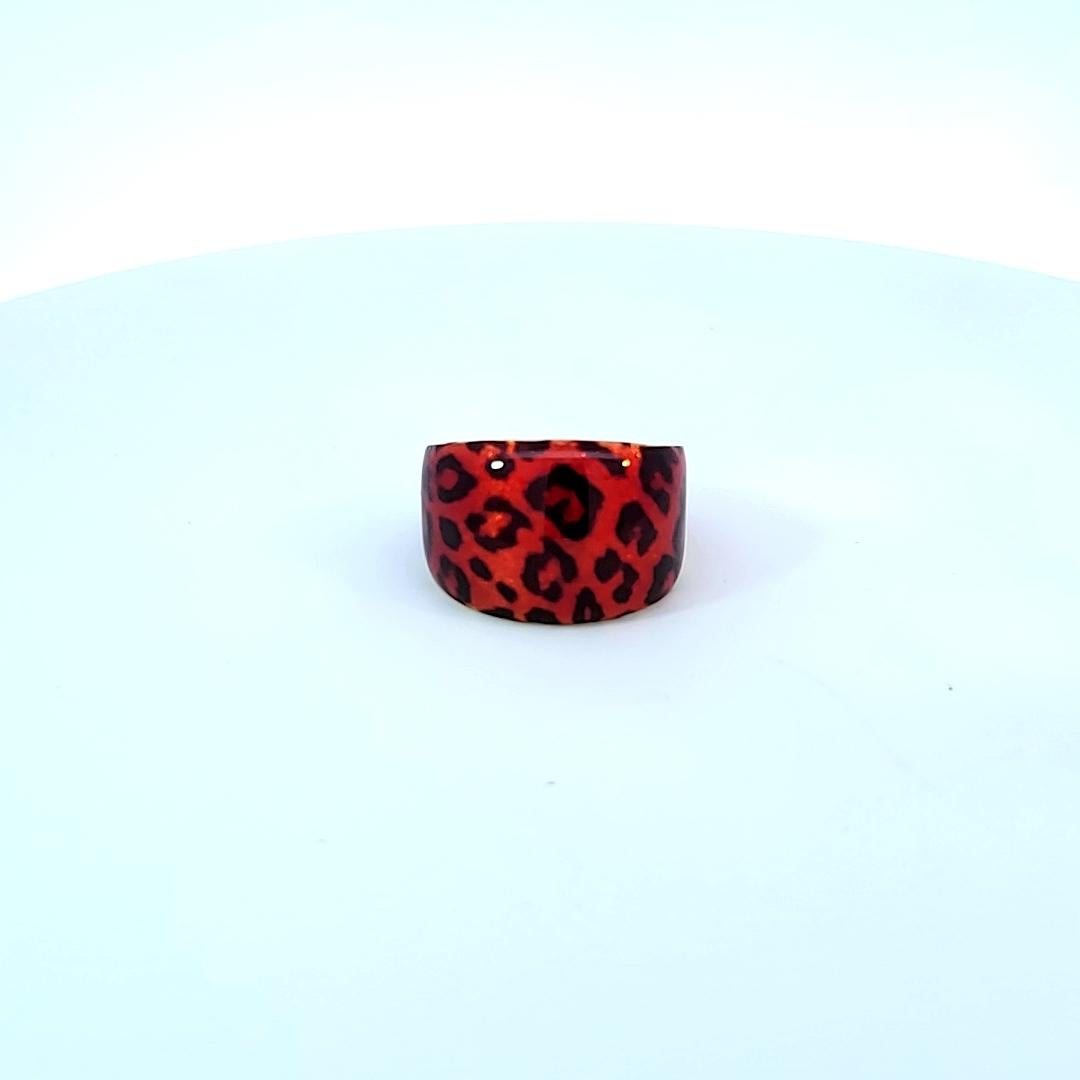 This fun ring is in 14 karat yellow gold and supports a red and black enamel upper portion! 