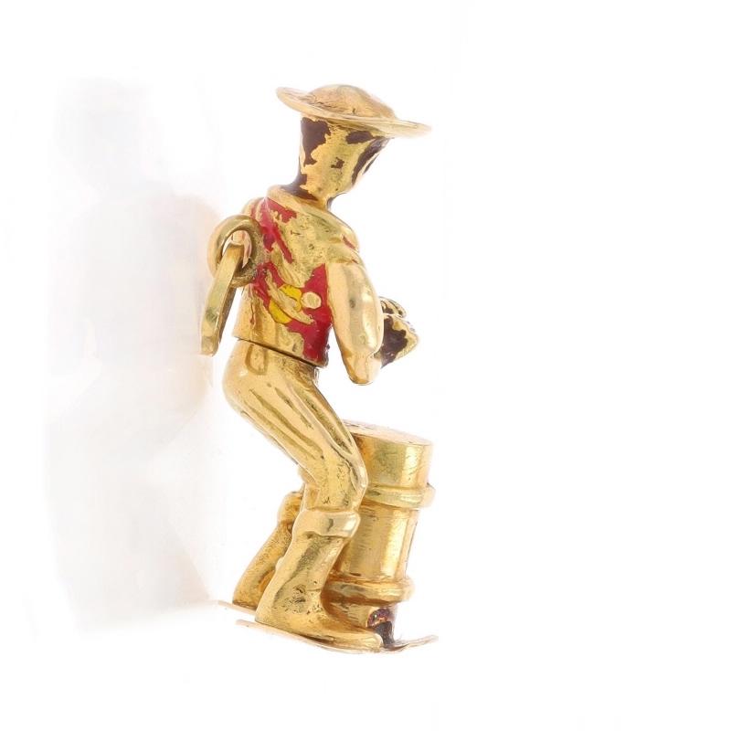 Era: Vintage

Metal Content: 18k Yellow Gold

Material Information
Enamel
Color: Brown, Red, & Yellow

Theme: Oil Barrel Drummer, Musician
Features: At the waist, the drummer moves from side-to-side.

Measurements
Tall: 1