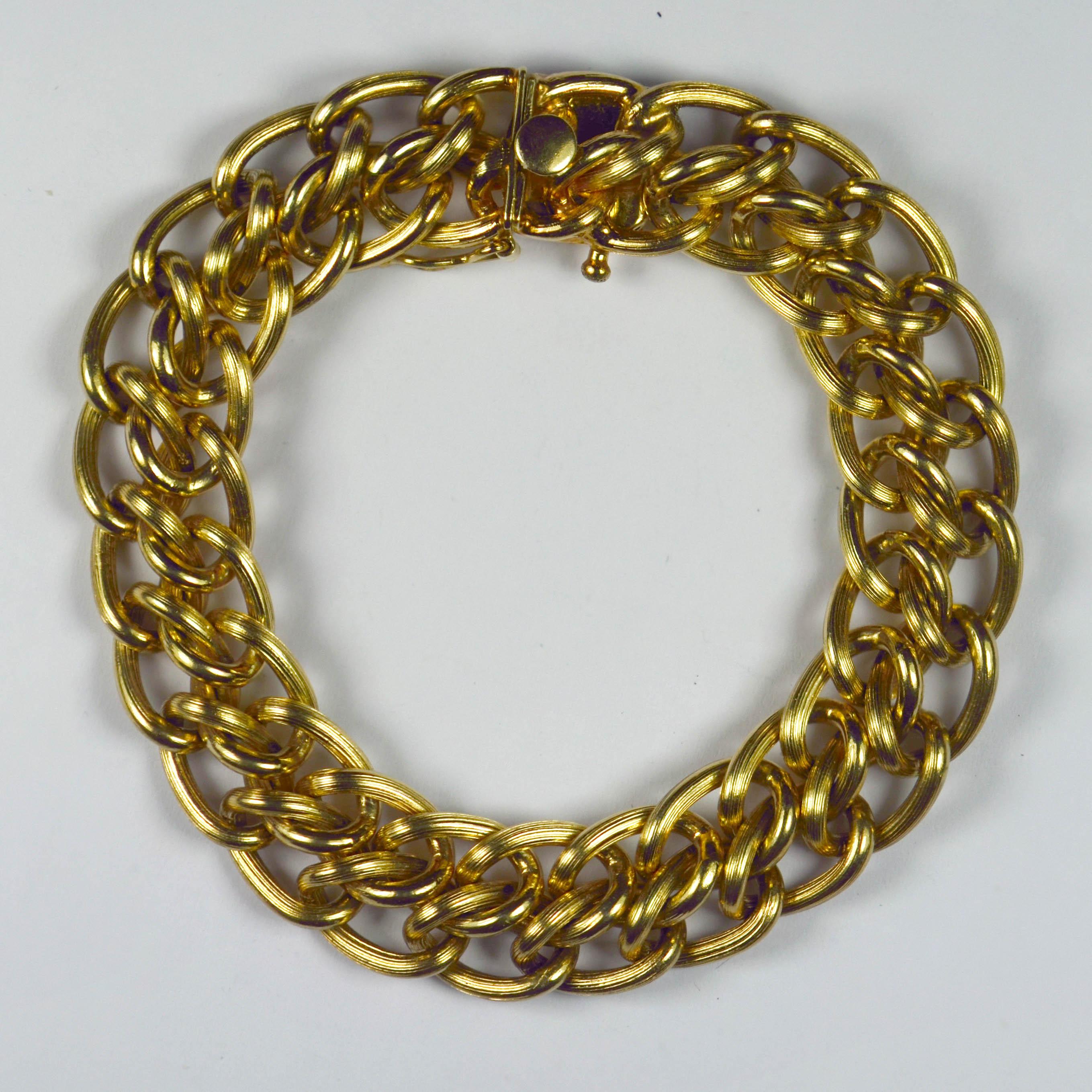 A 14 karat yellow gold double curb link bracelet with engraved lines to each link. Marked 14K to the box clasp for 14 karat gold, with safety catch for added security.

Dimensions: 7.5” (19cm) long, ½” (1.3cm) wide.
Weight: 54.72 grams
