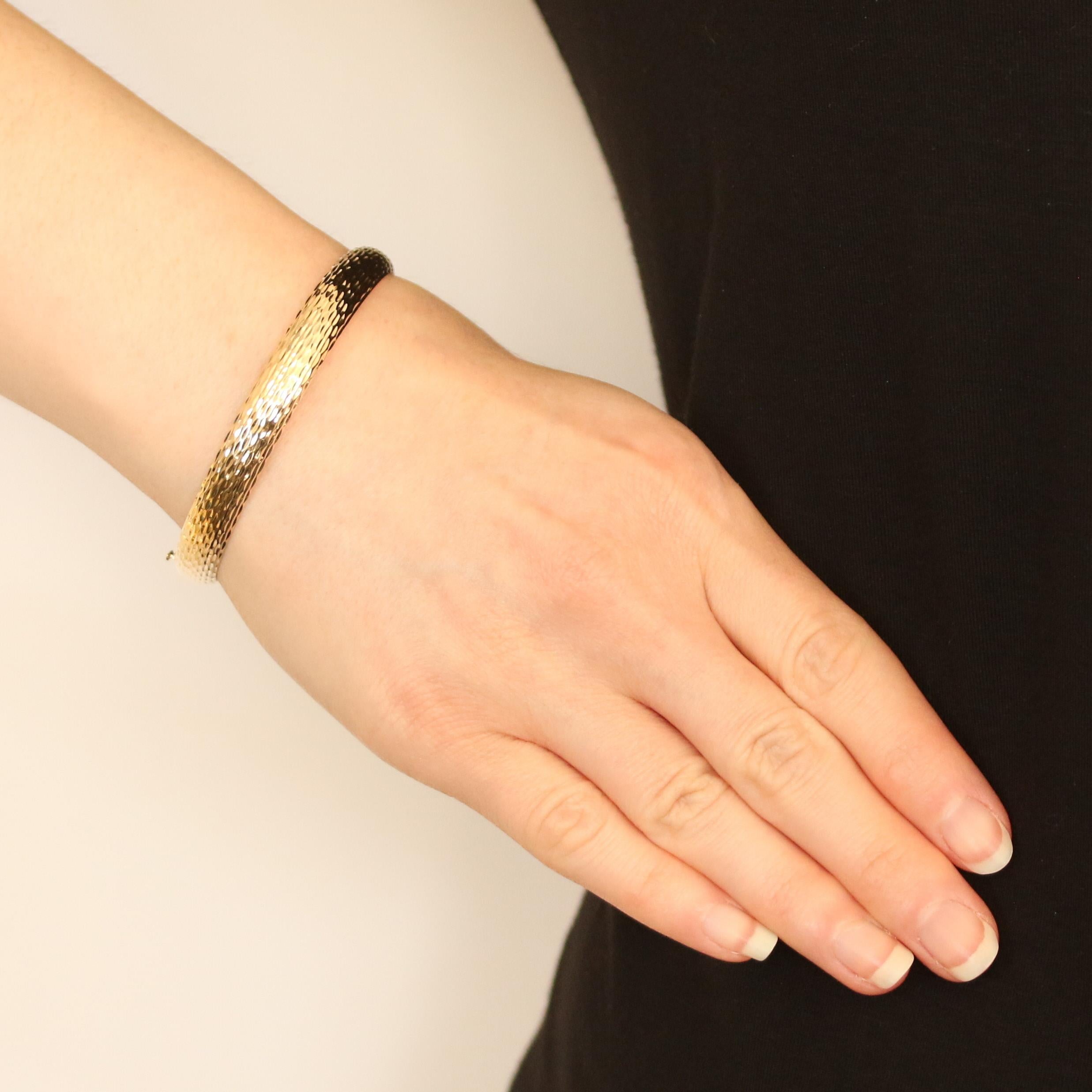 Metal Content: 14k Yellow Gold
 
 Bracelet Style: Hinged Bangle
 Closure Type: Slide Clasp
 Features: Etched & Smooth Finishes
 
 Measurements: 
 Inner circumference: 7