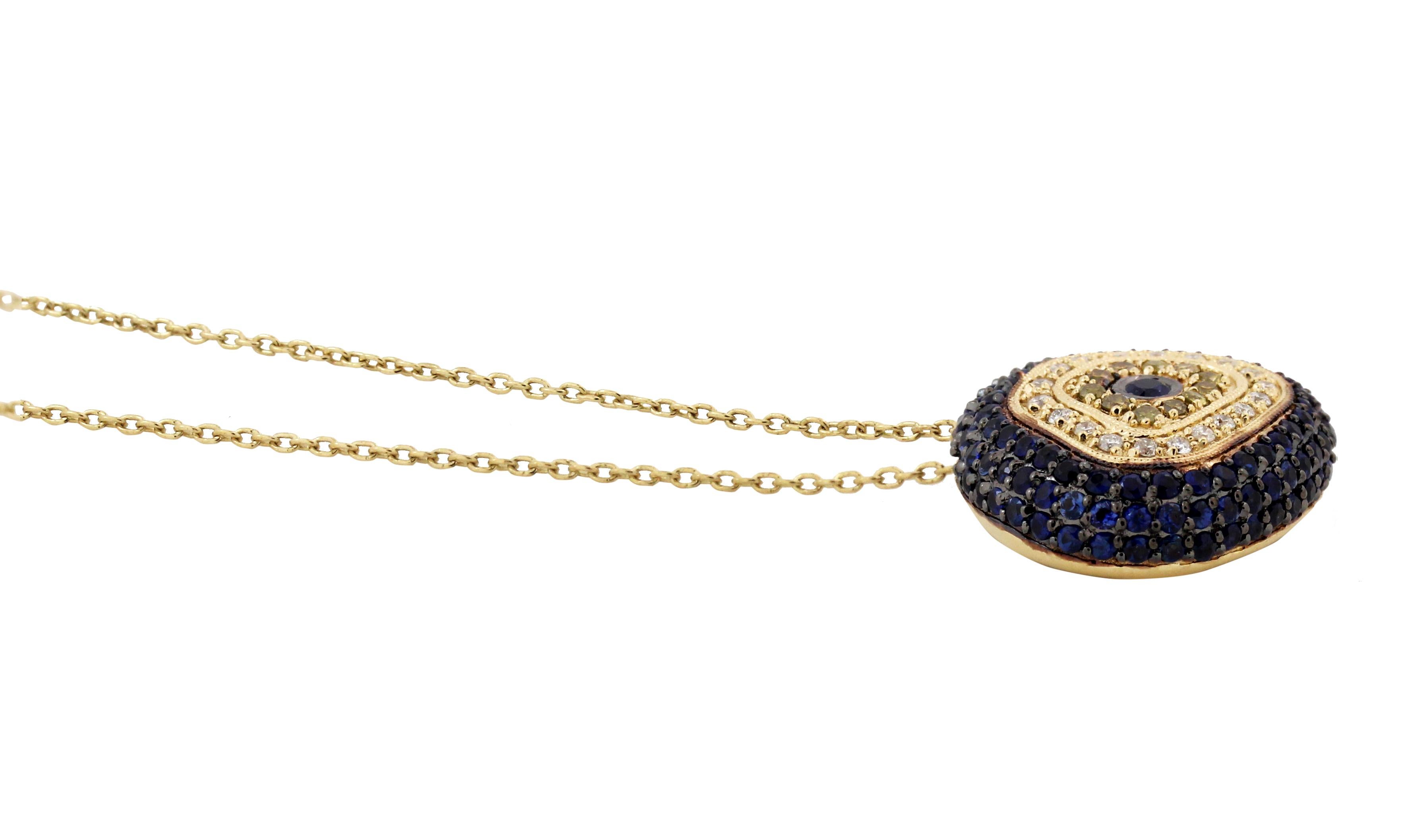 14K Yellow Gold Evil Eye Odd Shape Pendant Necklace with Diamonds and Sapphires
0.27 carat total weight H color, SI  clarity diamonds 
1.26 carat Blue and Yellow Sapphires
5.80  grams 14K gold  
19mm W x 17mm L face  / 17 inch chain total length.