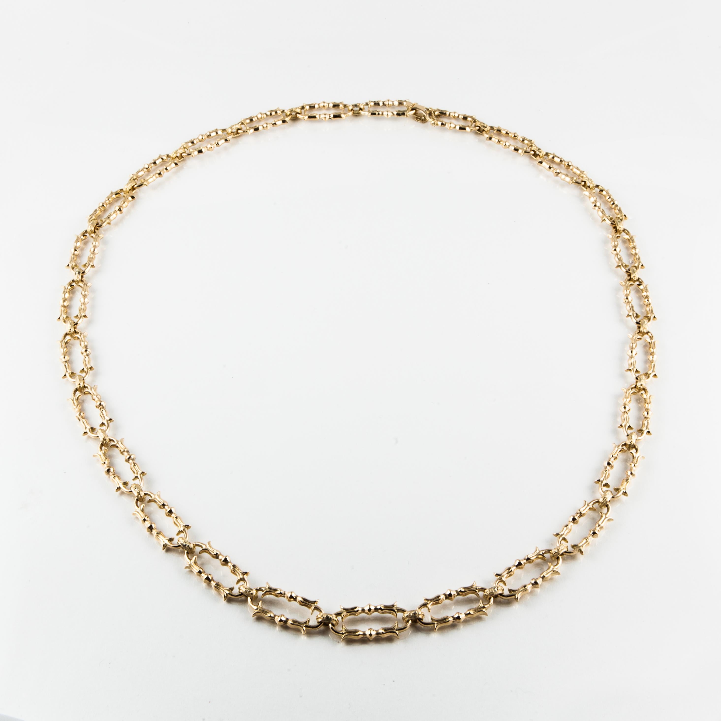 This necklace is composed of 18K yellow gold fancy links.  The necklace measures 32 inches in length.  Each link measures 1/2 inch wide and 1 1/8 inches long.  Has a fold over clasp.