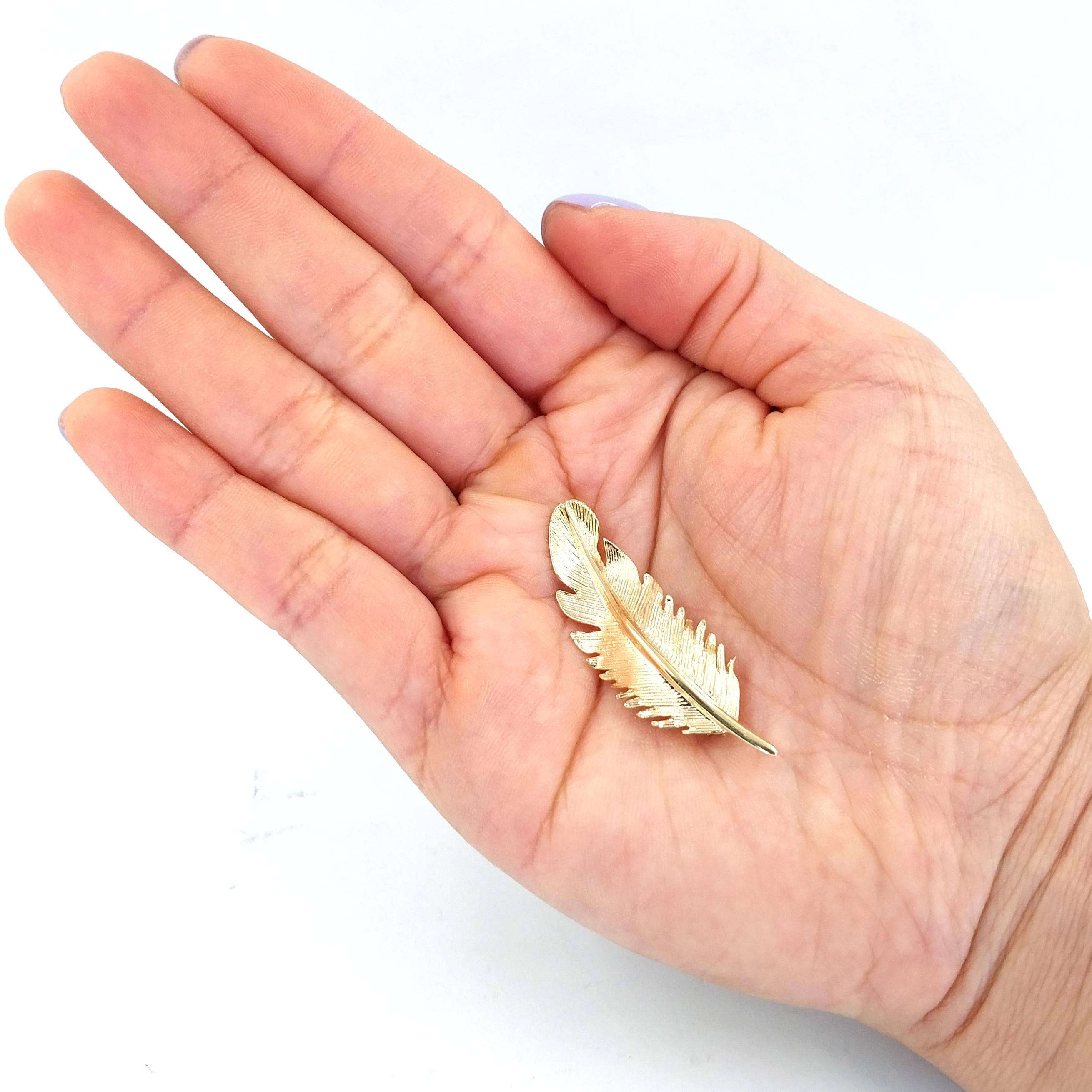 14 Karat Yellow Gold Feather Pin Featuring Textured Design. 1.75 Inches Long. Finished Weight is 3.6 Grams.