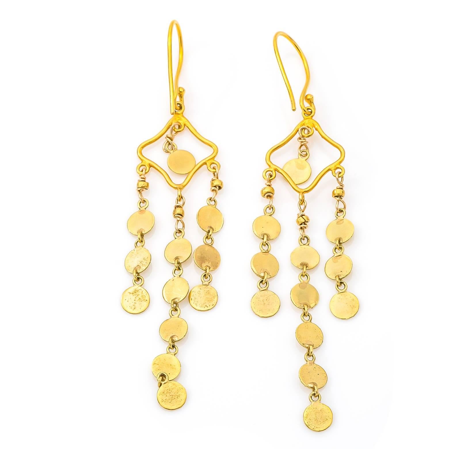 Strings of gold coins dangle and swing in 18K yellow gold. Lightweight and long these festive earrings dance around adding flare and excitement. Perfect for a walk in a Mediterranean breeze or a dance down a city street! 