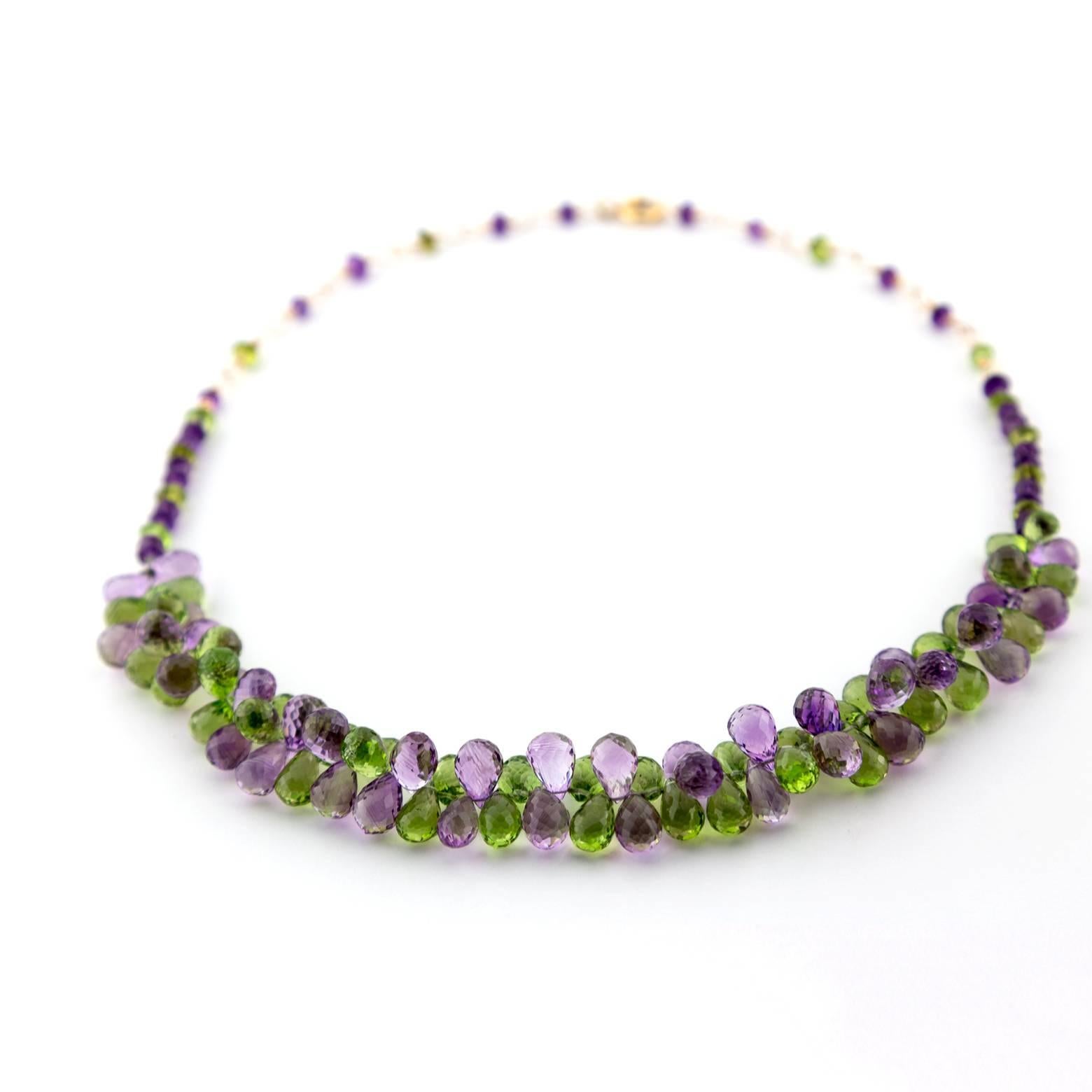 This piece is very dazzling! It's three dimensional movement allows it to sparkle catching all angles of light. It dances around your neck with beautiful shades of purple and green and has a comfortable delicate texture. It's fun, it's playful, it's