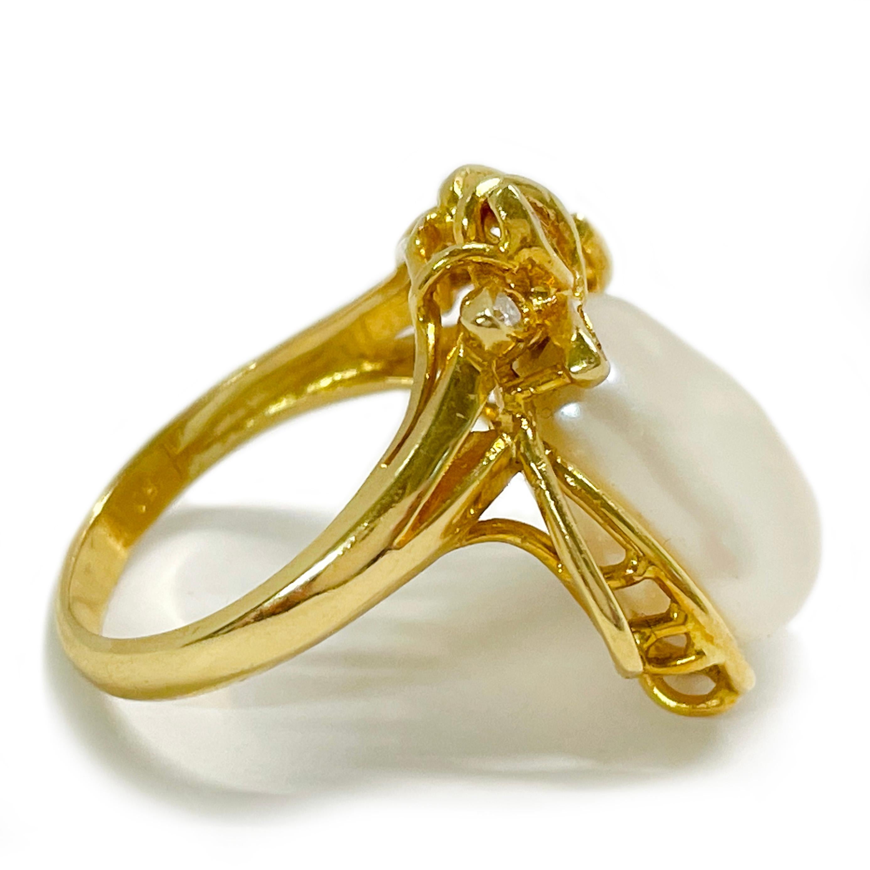 18 Karat Yellow Gold Flat Freshwater White Pearl Diamond Ring. The ring features a center pearl set in an open bezel with leaf-like open designs and six round diamonds added for detail. The pearl measures 13.8 x 12.4mm and has light color play of