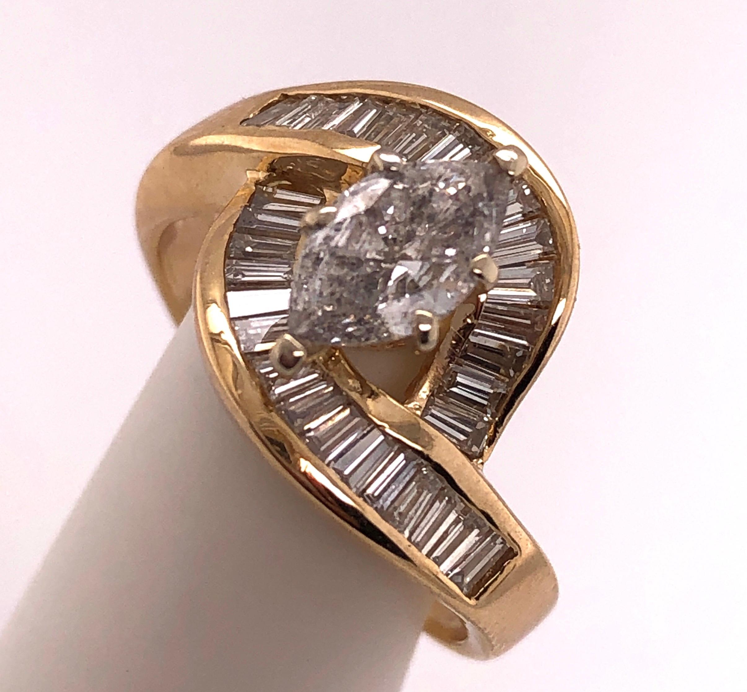 Yellow Gold Free Style Ring with Diamonds.
 0.75 carat center diamond and 34 pcs. baguette diamonds
Size 7.75 with 5.6 grams total weight