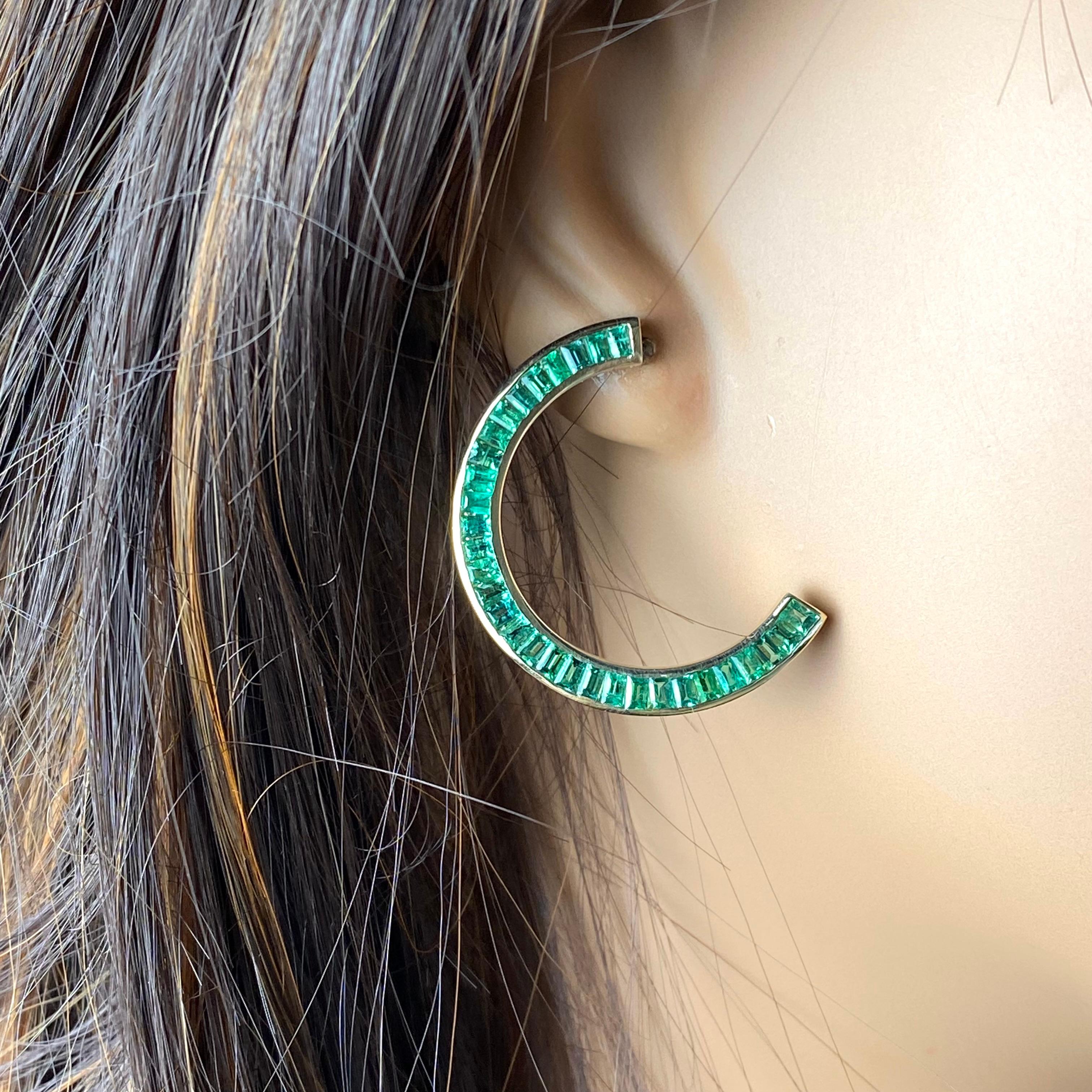 Introducing our exquisite 14 karat yellow gold front facing half moon earrings, meticulously crafted to captivate with elegance and sophistication. These stunning earrings boast a total of 62 perfectly matched baguette emeralds, each meticulously