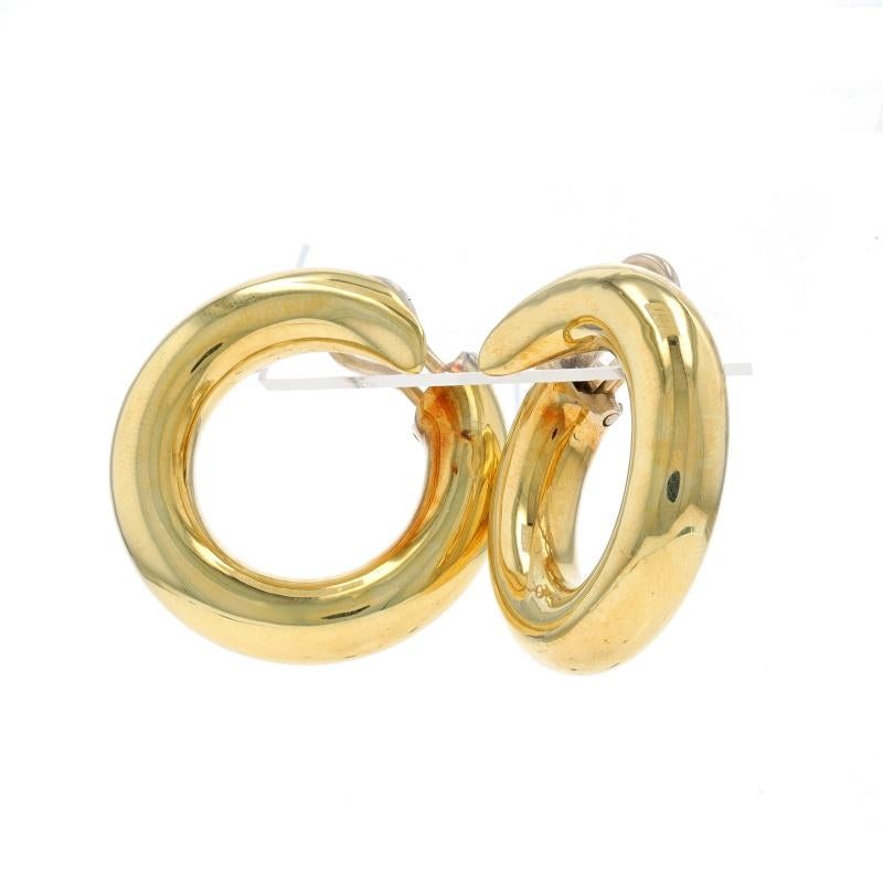 Metal Content: 18k Yellow Gold

Style: Front Hoop
Fastening Type: Omega Closures
Features: Hollow construction for comfortable, all-day wear

Measurements
Tall: 1 7/32