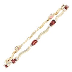 Yellow Gold Garnet and Diamond Link Bracelet, 10 Karat Oval Cut 2.25 Carat
