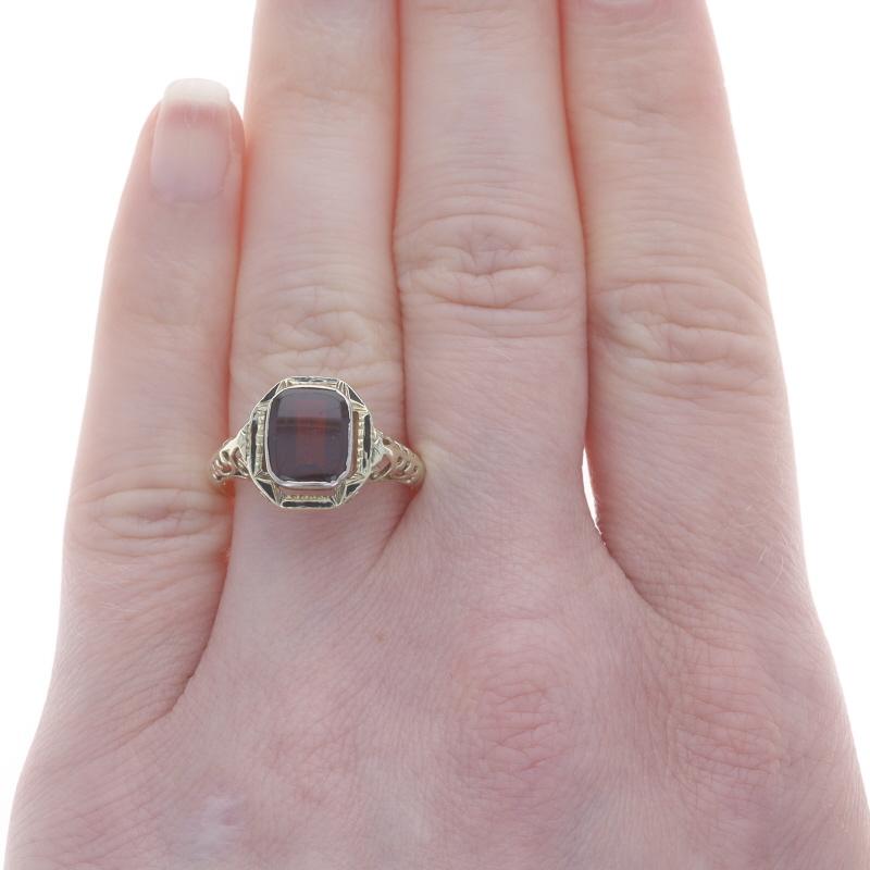 Size: 8
Sizing Fee: Up 3 sizes for $40 or Down 2 sizes for $30

Era: Art Deco
Date: 1920s - 1930s

Metal Content: 14k Yellow Gold & 14k White Gold

Stone Information

Natural Garnet
Cut: Rectangular Cushion
Color: Red

Material