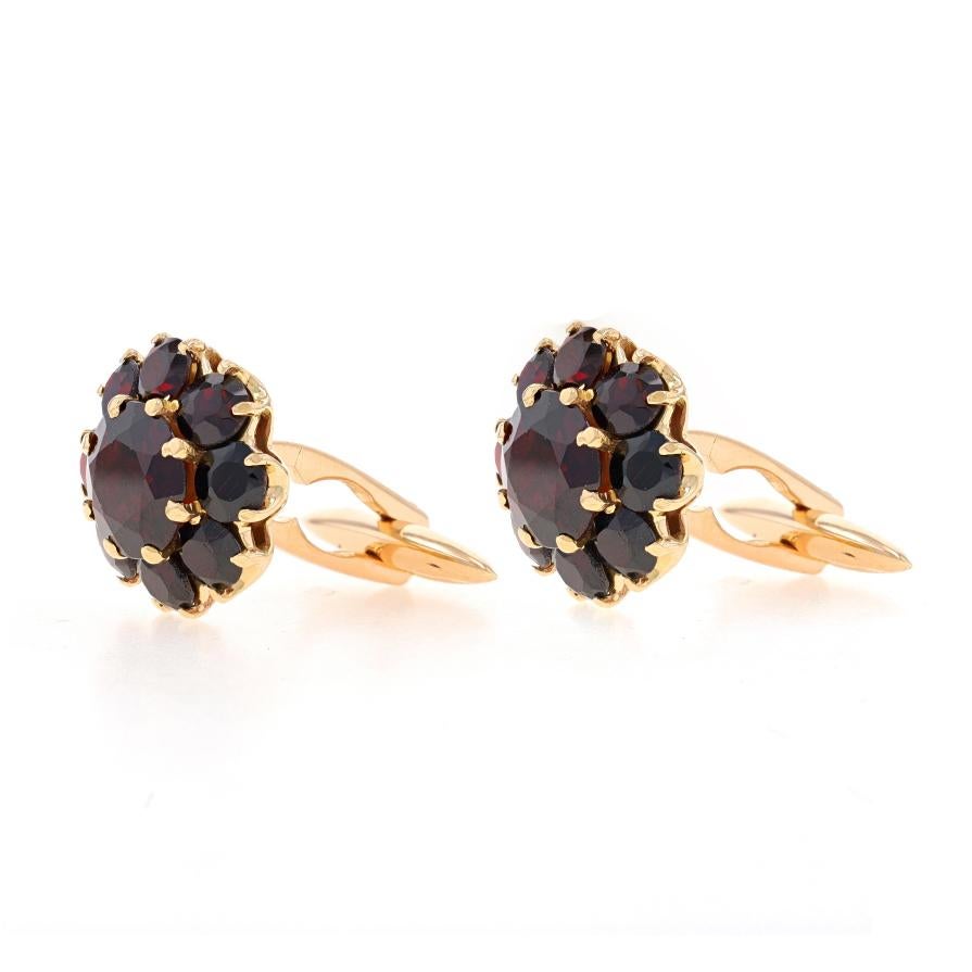 Metal Content: 18k Yellow Gold

Stone Information
Natural Garnets
Carat(s): 11.20ctw
Cut: Round
Color: Red

Total Carats: 11.20ctw

Style: Cluster Halo Cufflinks
Theme: Floral

Measurements
Tall: 21/32