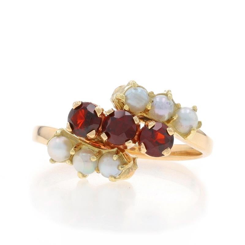 Size: 6 3/4
Sizing Fee: Up 2 1/2 sizes for $30 or Down 1 size for $30

Metal Content: 14k Yellow Gold

Stone Information

Natural Garnets
Carat(s): .63ctw
Cut: Round
Color: Red

Cultured Pearls
Color: White

Total Carats: .63ctw

Style: Three-Stone