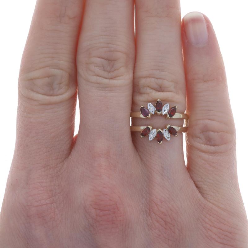 Size: 5 1/2
Sizing Fee: Up 2 sizes for $70 or Down 1 size for $60
Note: When re-sized, the shank's vertical center cross bar will be removed.

Metal Content: 14k Yellow Gold & 14k White Gold

Stone Information
Natural Garnets
Carat(s): .45ctw
Cut: