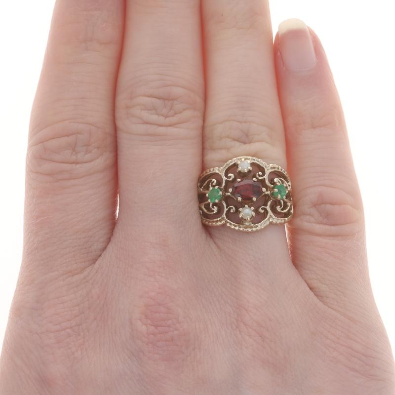 Size: 5 3/4
Sizing Fee: Up 2 1/2 sizes for $40 or Down 1 3/4 sizes for $30

Metal Content: 14kYellow Gold

Stone Information

Natural Garnet
Carat(s): .55ct
Cut: Oval
Color: Red

Natural Emeralds
Treatment: Oiling
Carat(s): .24ctw
Cut: Round
Color:
