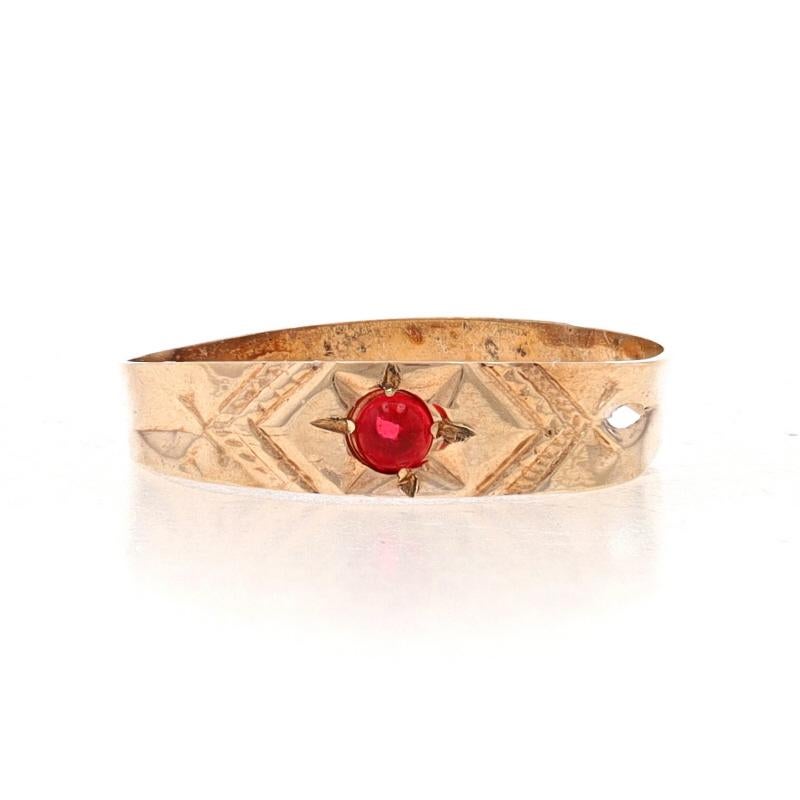 Size: 1

Era: Victorian
Date: 1870s - 1880s

Metal Content: 10k Yellow Gold

Stone Information
Natural Garnet
Cut: Round Cabochon
Color: Red

Style: Solitaire Band
Theme: Starburst
Features: Etched Detailing

Measurements
Face Height (north to