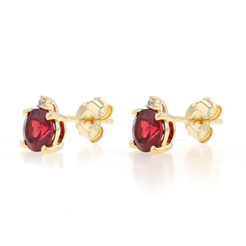 Metal Content: 10k Yellow Gold & 10k White Gold

Stone Information
Natural Garnets
Carat(s): 2.00ctw
Cut: Round
Color: Red

Natural White Topaz
Carat(s): .04ctw
Cut: Round

Total Carats: 2.04ctw

Style: Stud
Fastening Type: Butterfly