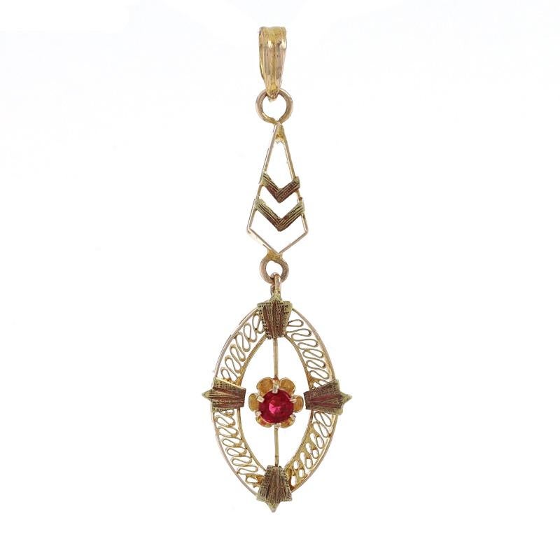 Era: Art Deco
Date: 1920s - 1930s

Metal Content: 14k Yellow Gold

Stone Information

Glass/Garnet Doublet
Cut: Round
Color: Red

Style: Solitaire
Features: Filigree Detailing

Measurements

Tall (from stationary bail): 1 5/16