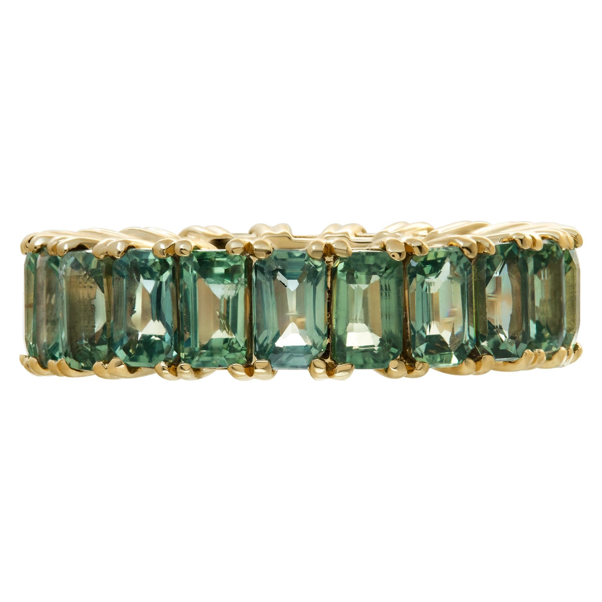 Green sapphire eternity band in 14k yellow gold with 8.12 carats in emerald cut green sapphires. Size 7, width 6mm.
